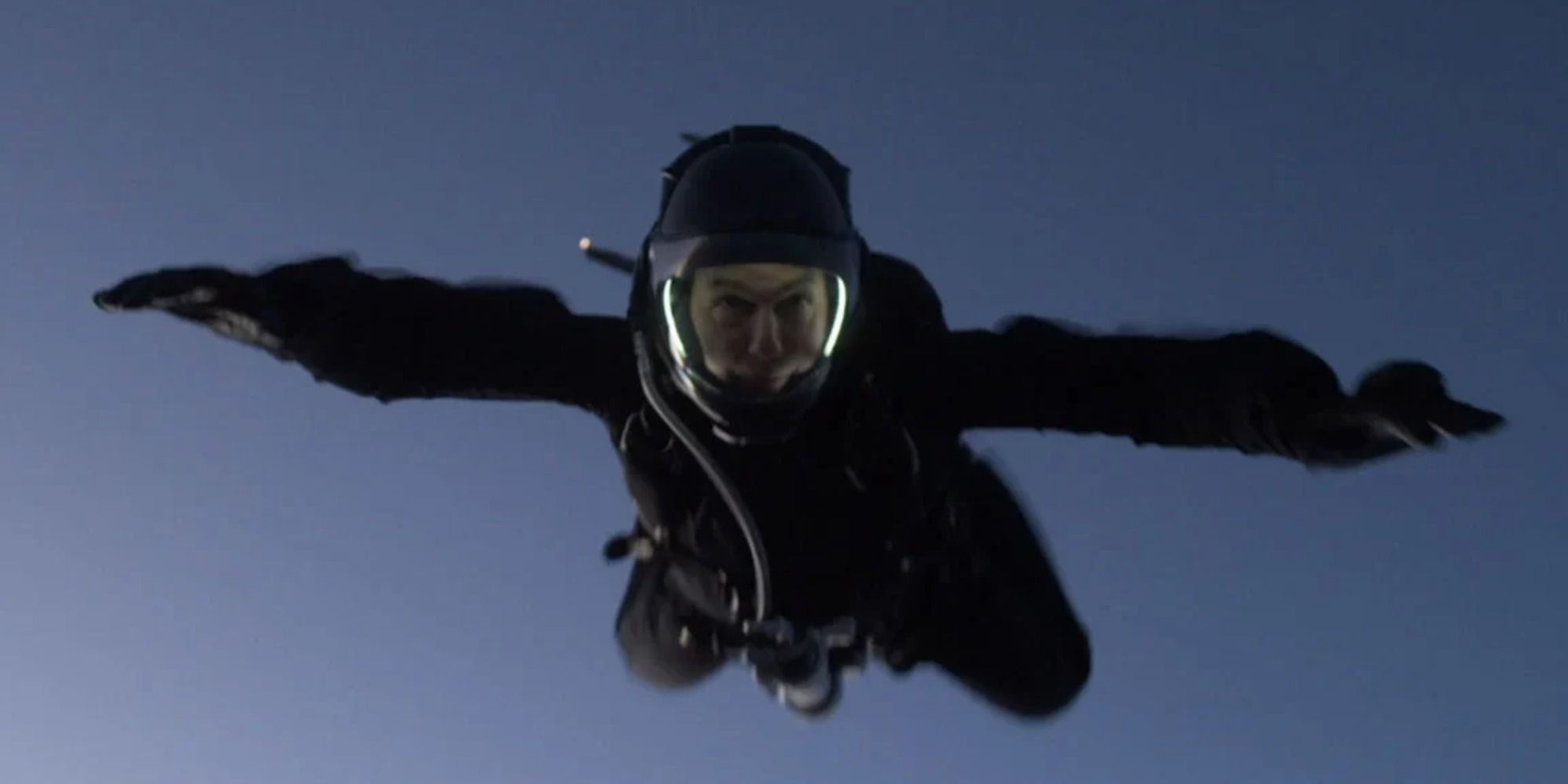 Ethan Hunt jumps from a plane wearing a parachute suit and free falls.