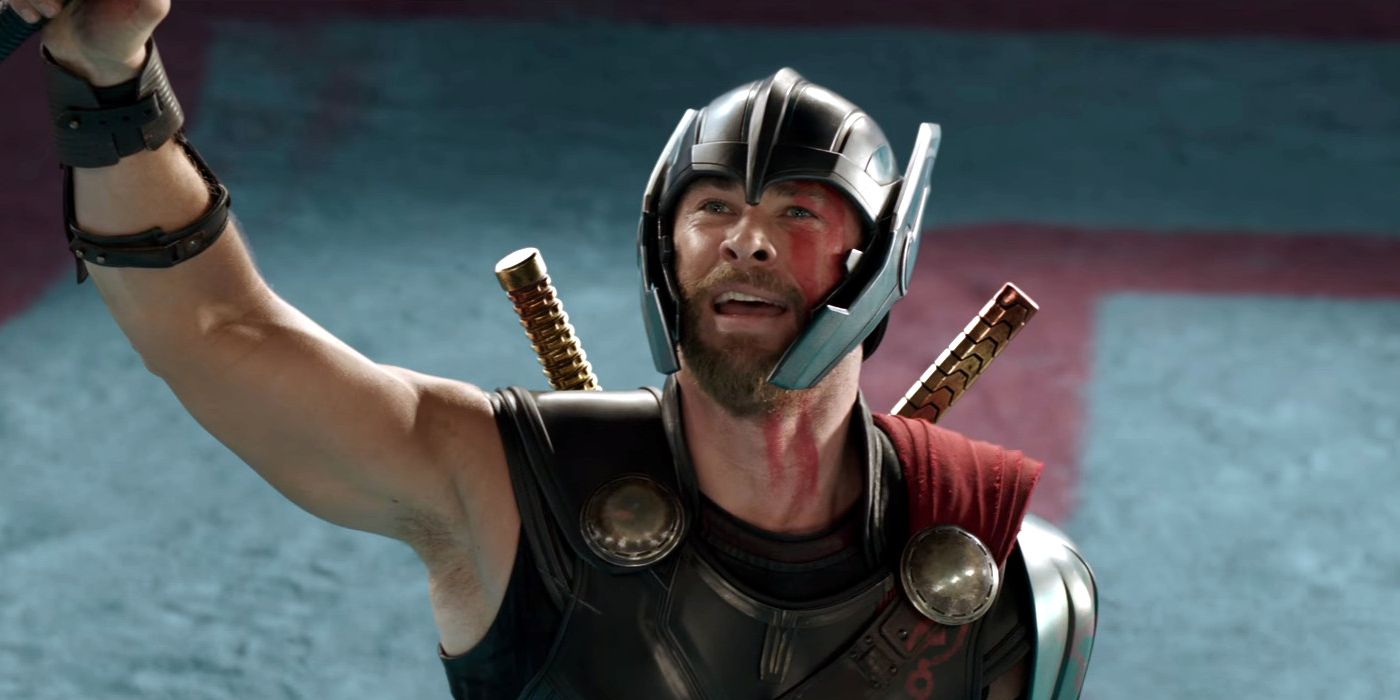 Adorned in armor, Thor waves at the Grandmaster's box as he stands in the gladiator arena on Sakaar. 