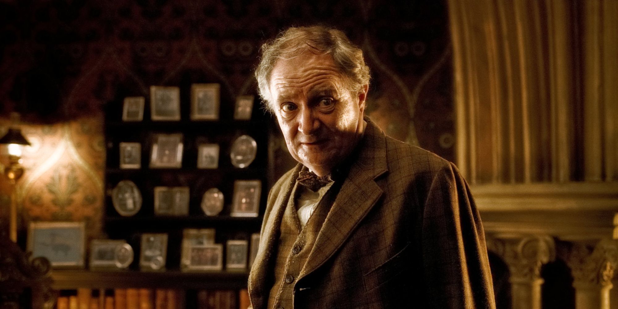 Slughorn in his office in front of a wall of photos