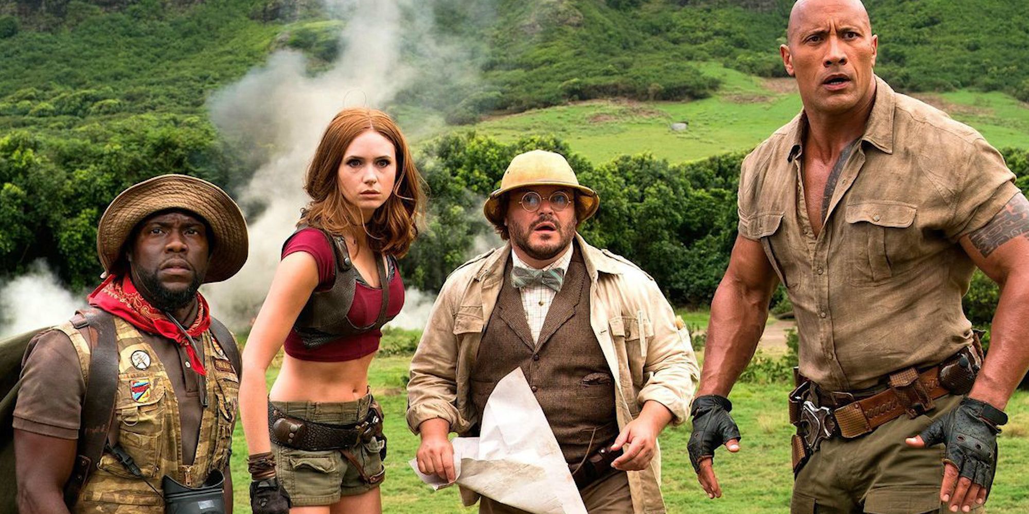 The cast of Jumanji Welcome to the Jungle on a vast mountain, looking ahead with confused expressions