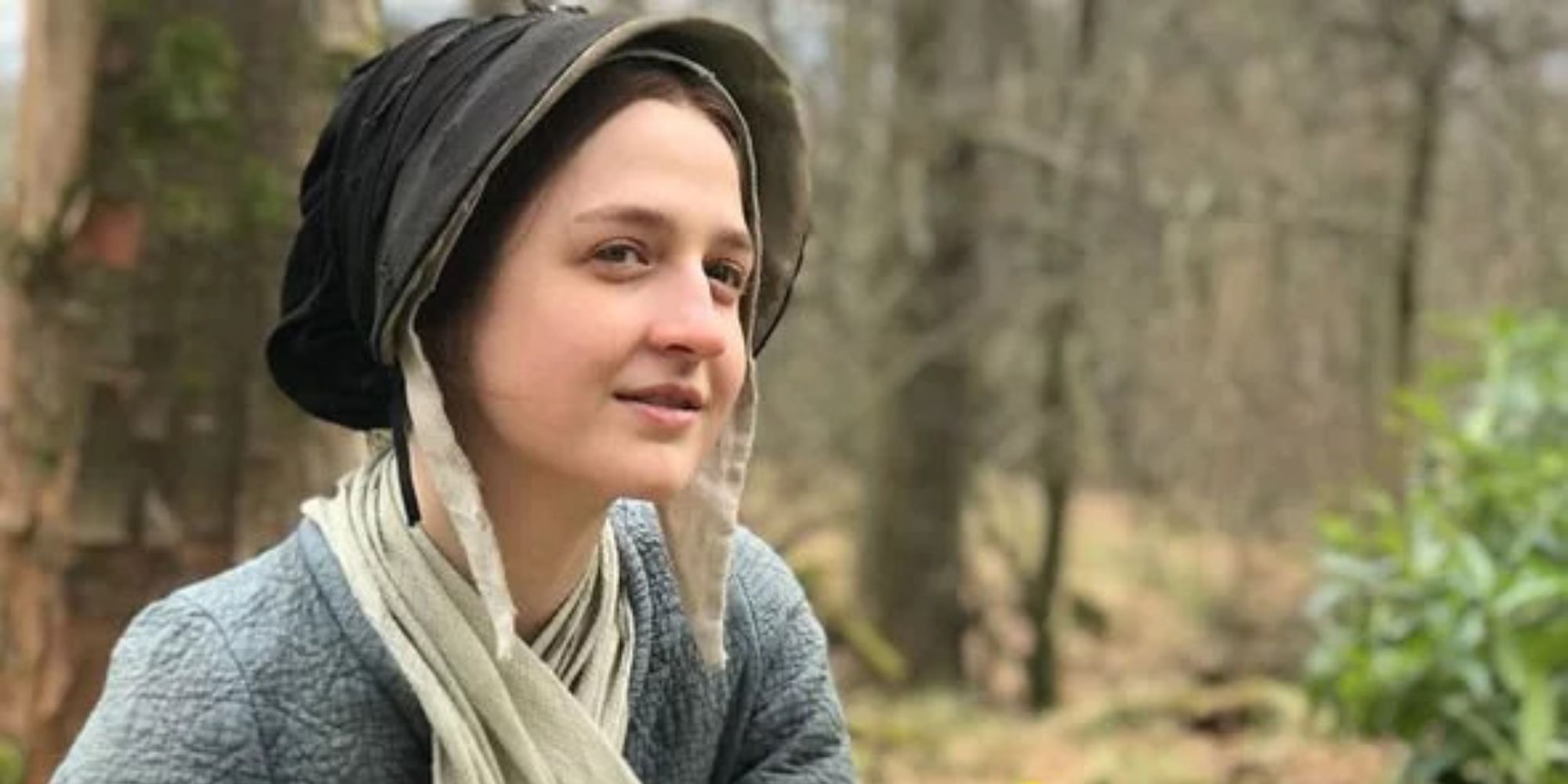 Lizzie Wemyss in a cap with the forest in the background