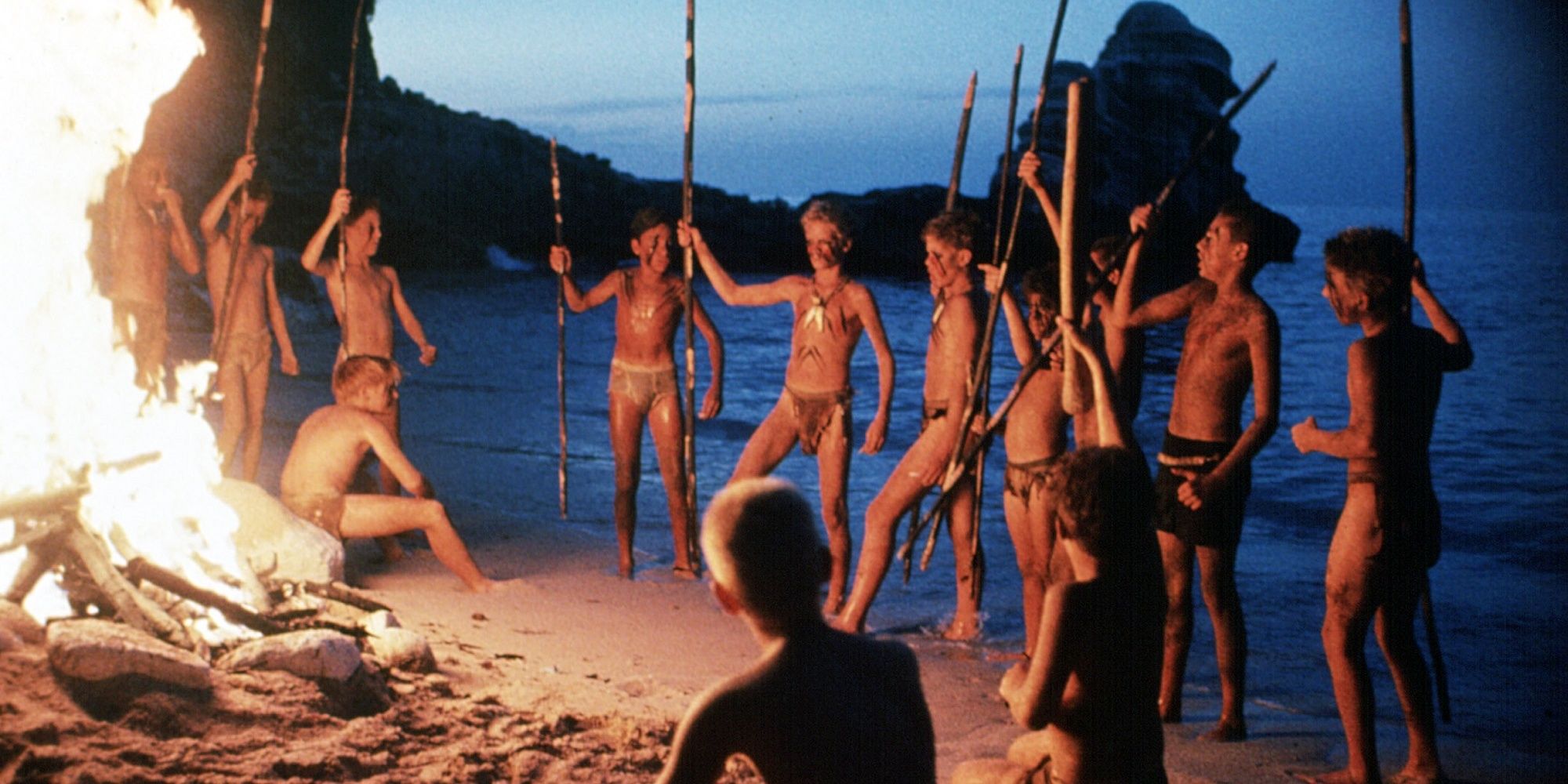 The schoolboys around a bonfire in the Lord of Flies.