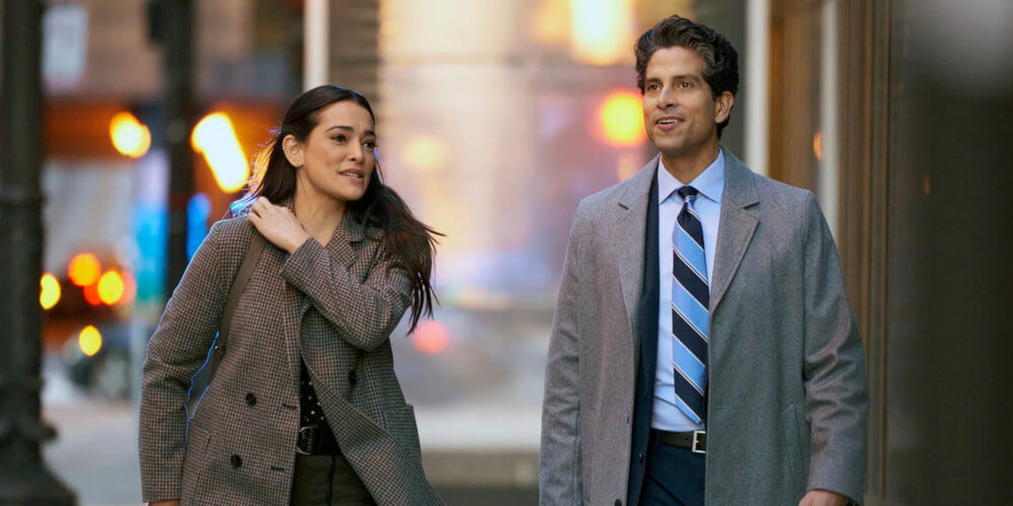 A man and a woman walking down the street