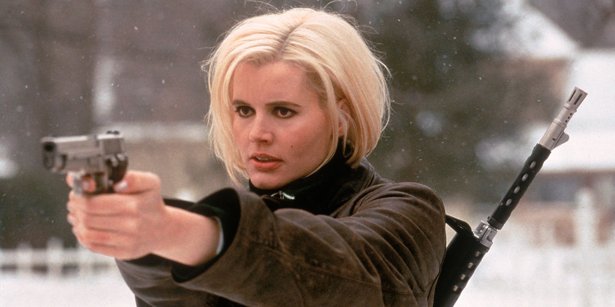 A blonde woman is aiming her gun at someone