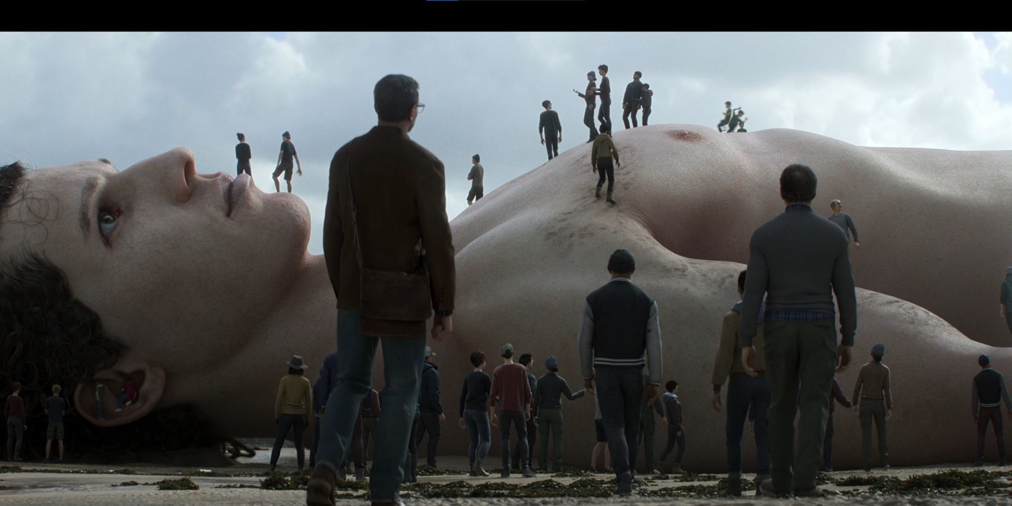 People are surrounding a dead giant