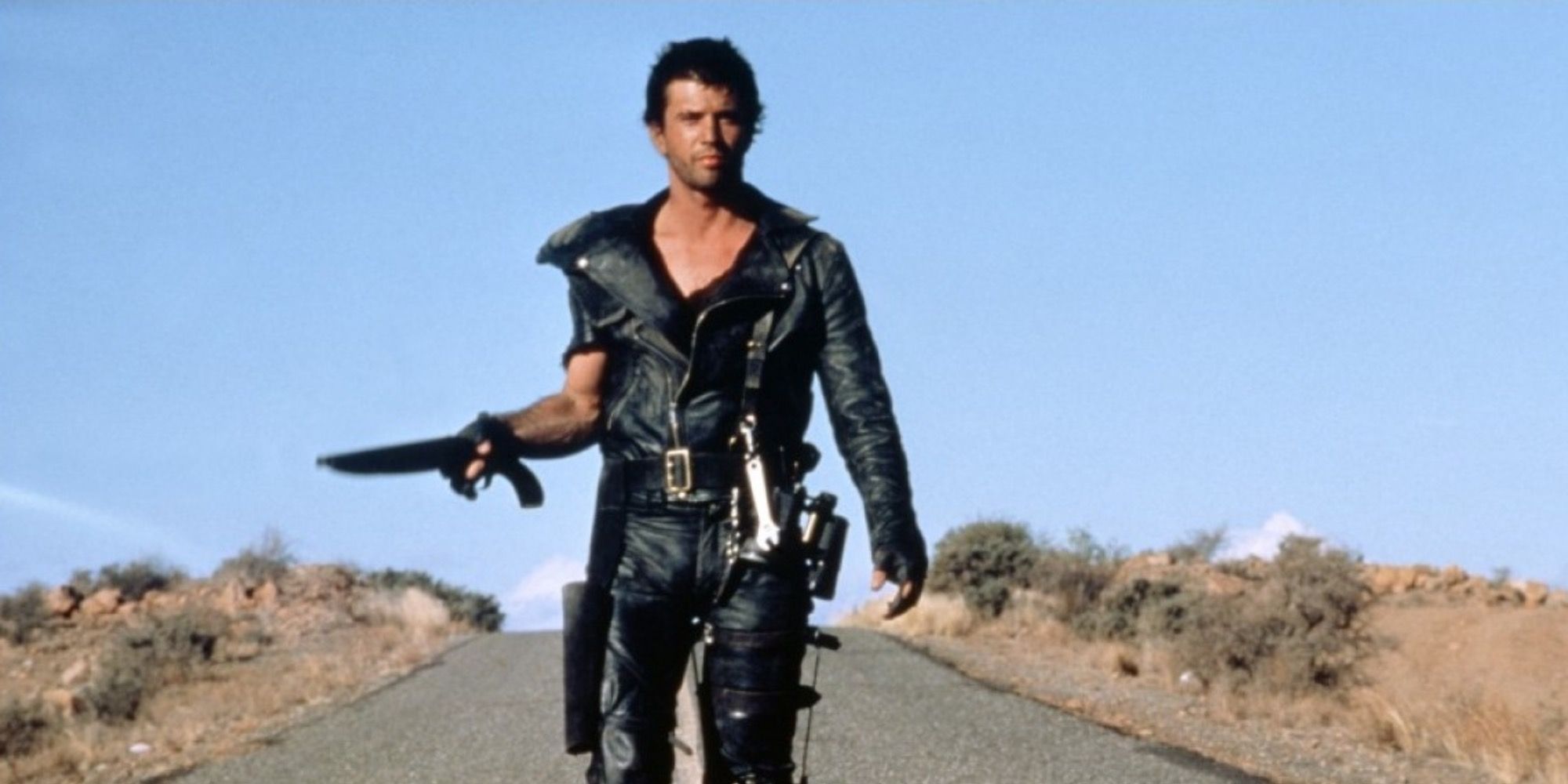 Mad Max walking with a weapon