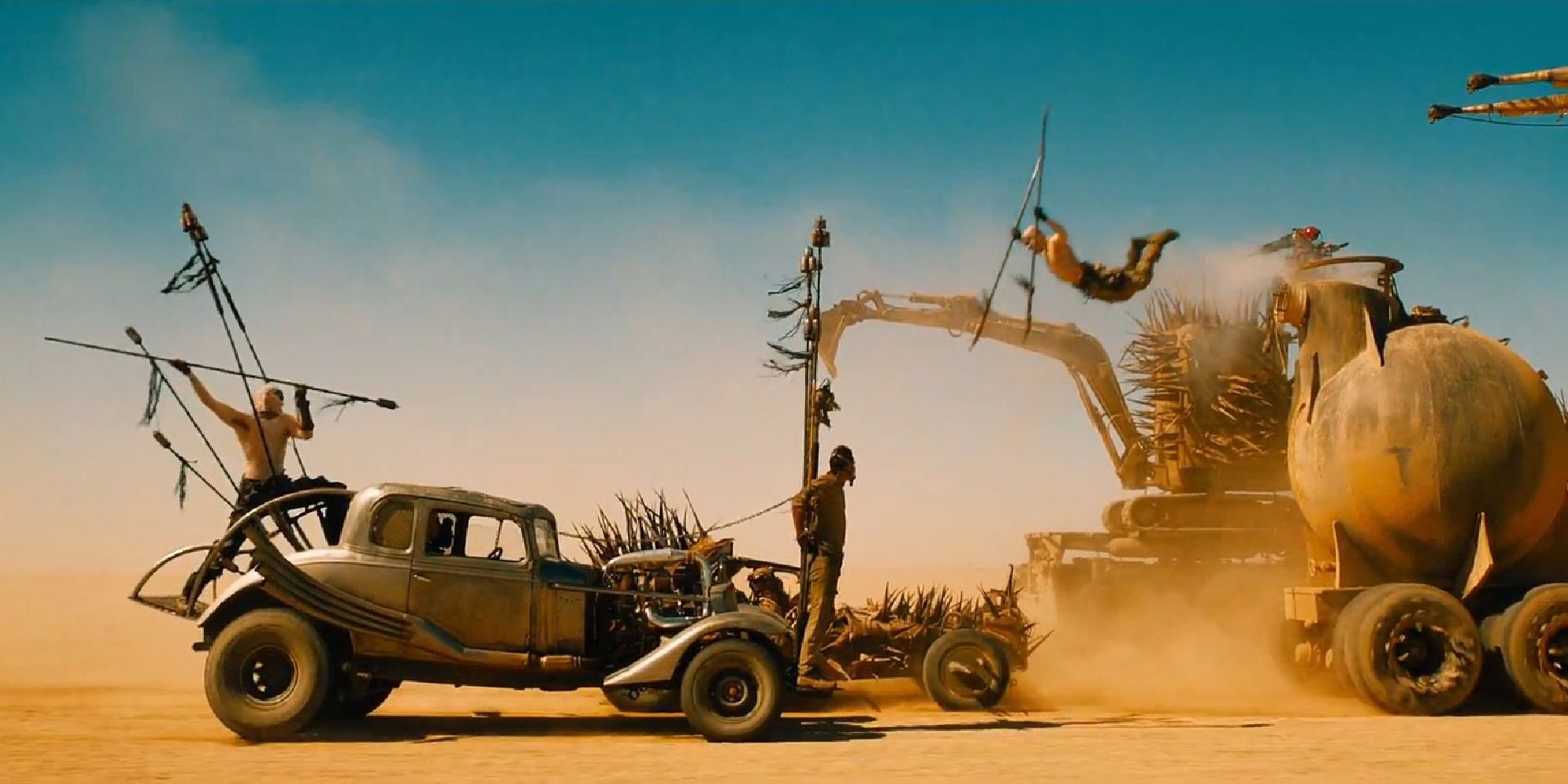 A War Boy jumps from car to car in Mad Max: Fury Road