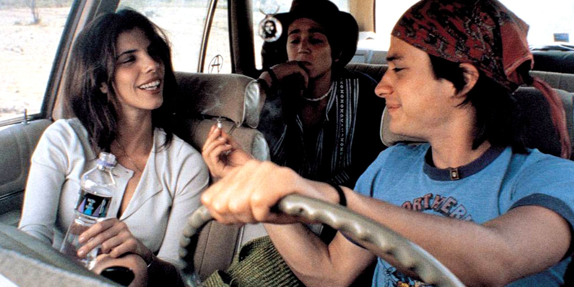 main characters of &ldquo;Y Tu Mamá También&rdquo;, in a car, smoking a joint