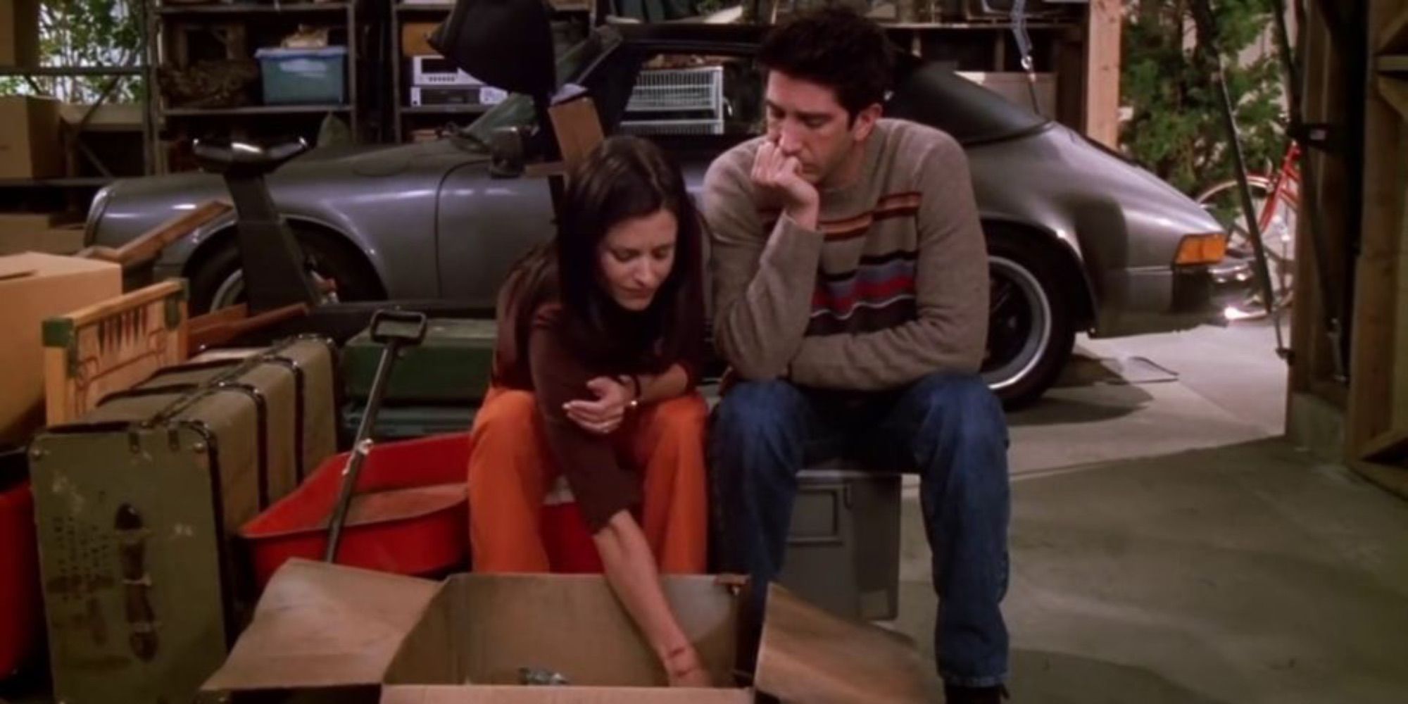 ross and Monica looking at Monica's childhood items