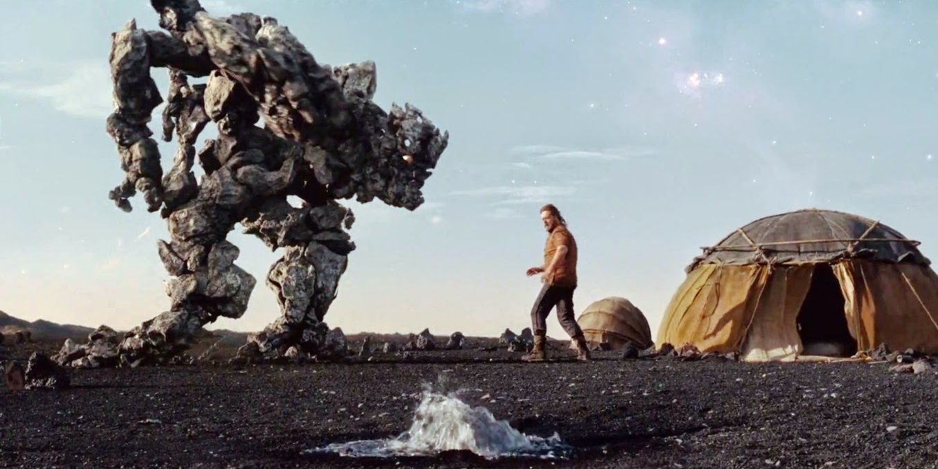 Noah standing before a massive rock creature outisde a tent in 2014's Noah.