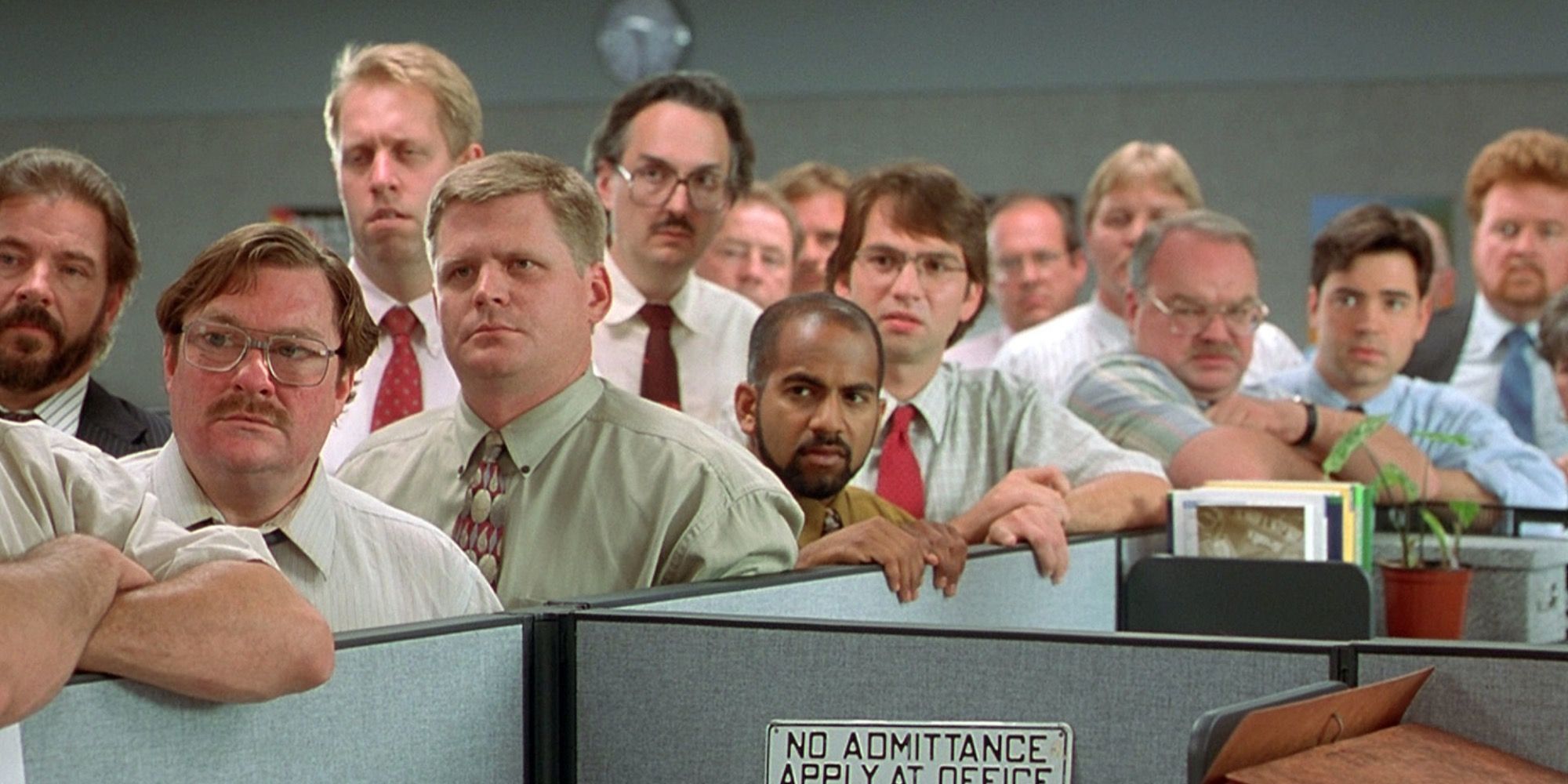 The cast of Office Space huddled together