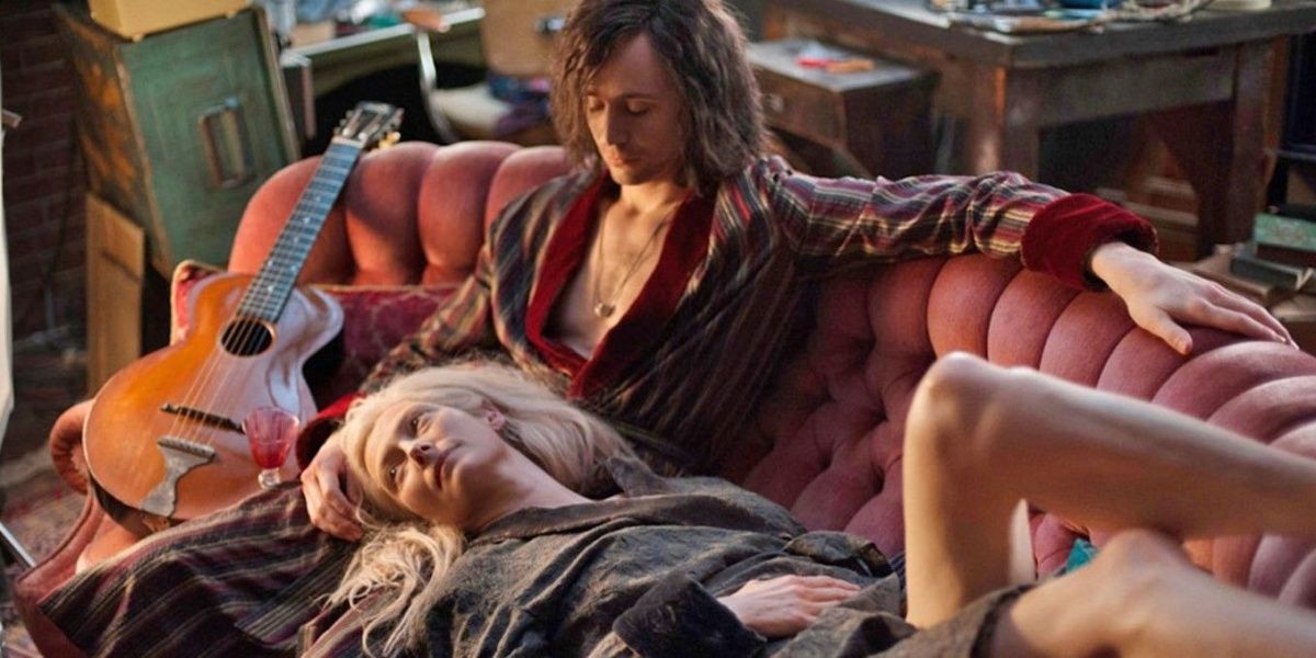 Eve (Tilda Swinton) laying on a chaise lounge with her head in Adam's (Tom Hiddleston)'s lap in "Only Lovers Left Alive"