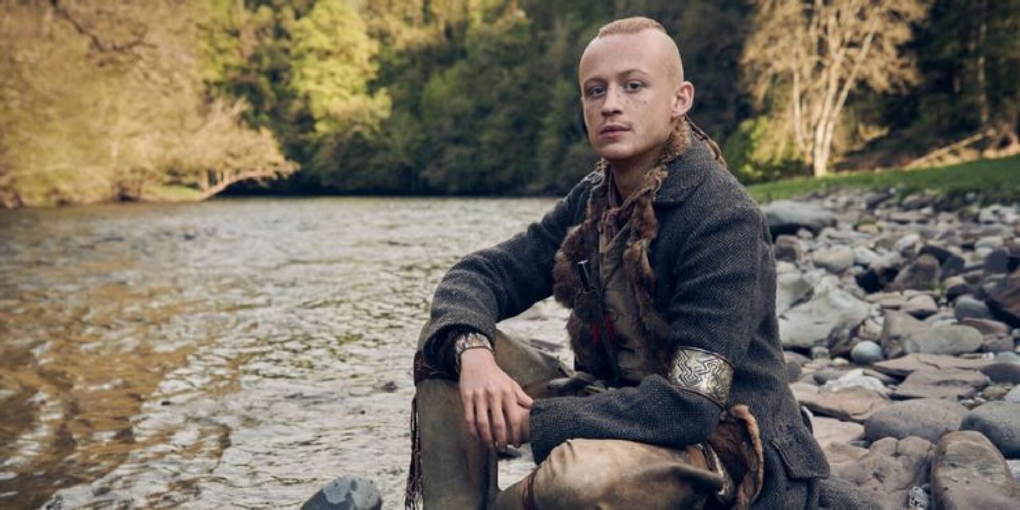 Ian Fraser, played by John Bell, sitting along a river with a mohawk in 'Outlander.' 