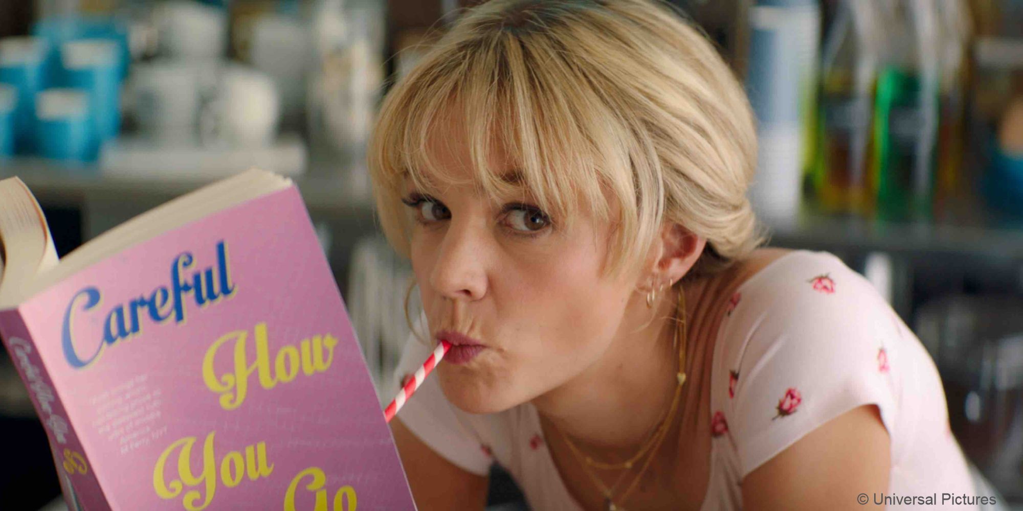 Promising Young Woman_Cassie reads a book while sipping on a drink