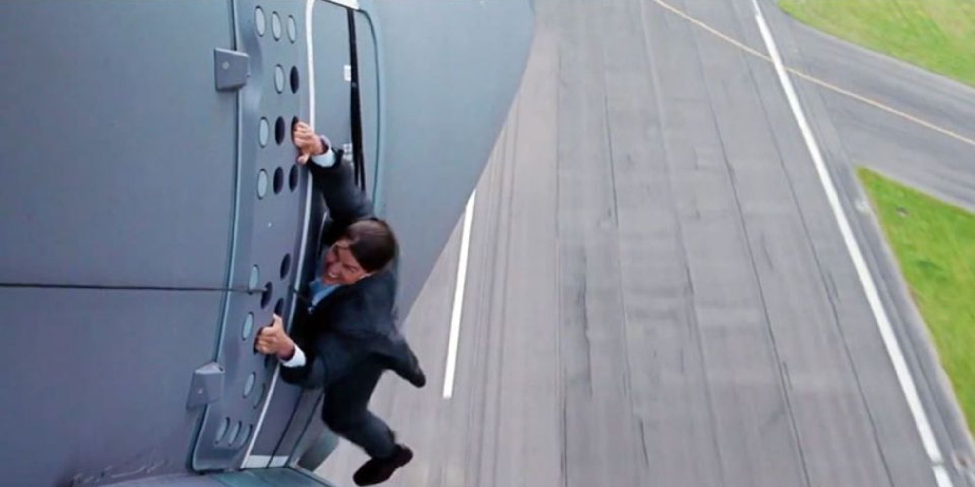 mission impossible tom cruise hanging on a plane