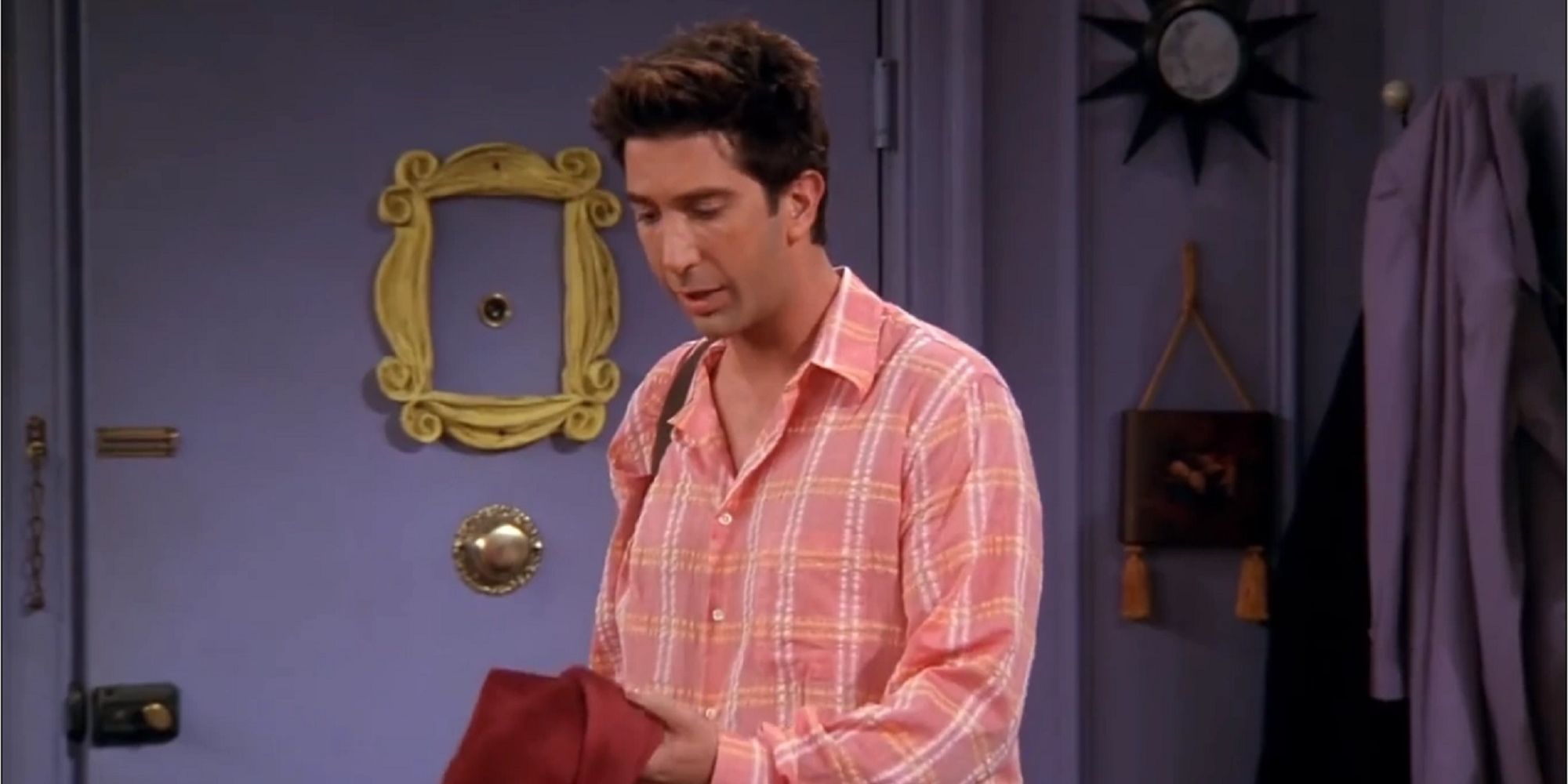 Ross holding a red sweater