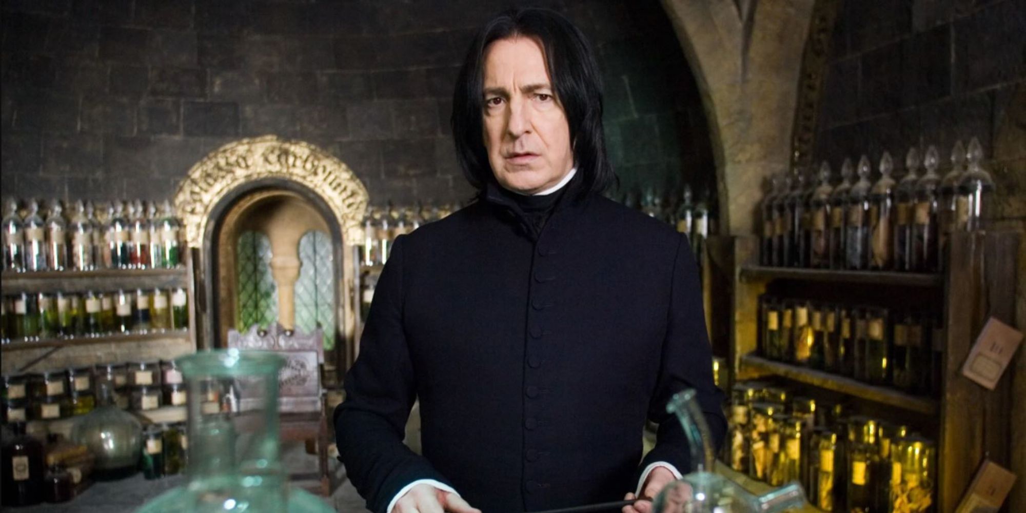 Severus Snape stands impassively in his room full of potions