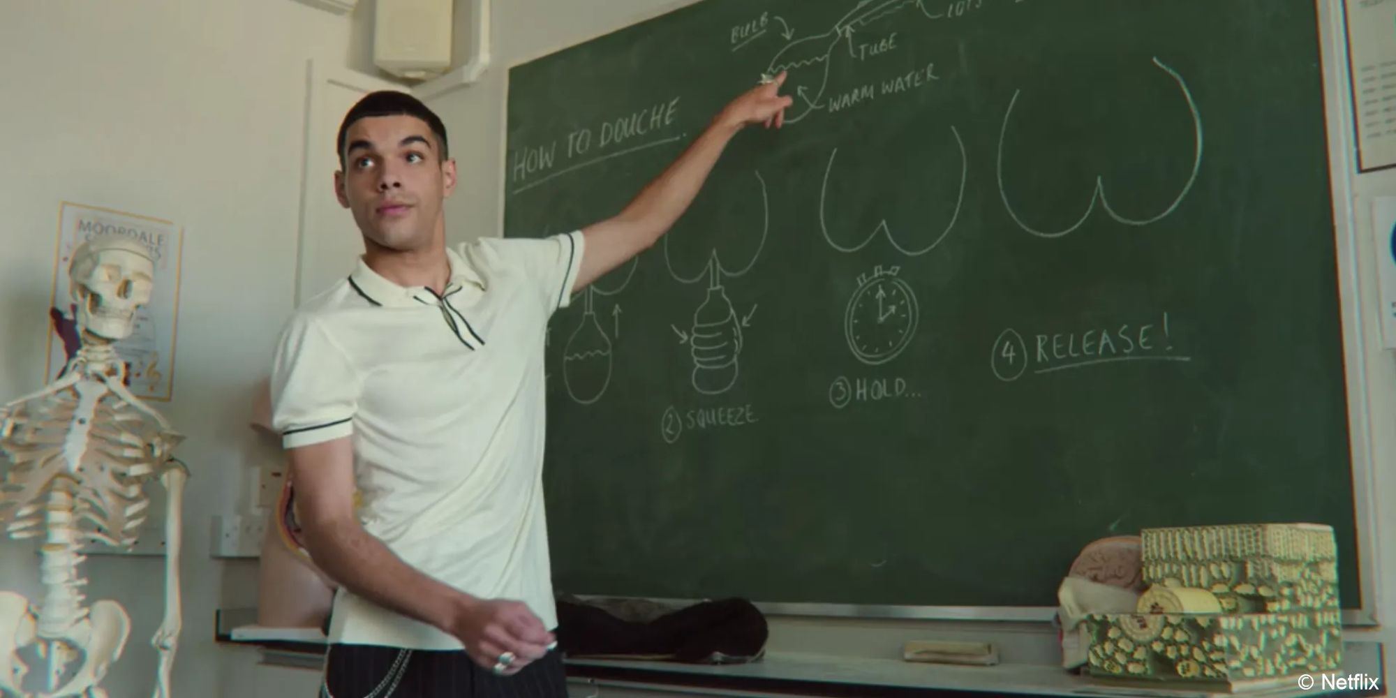 Sex Education_Rahim teaches students from a chalkboard