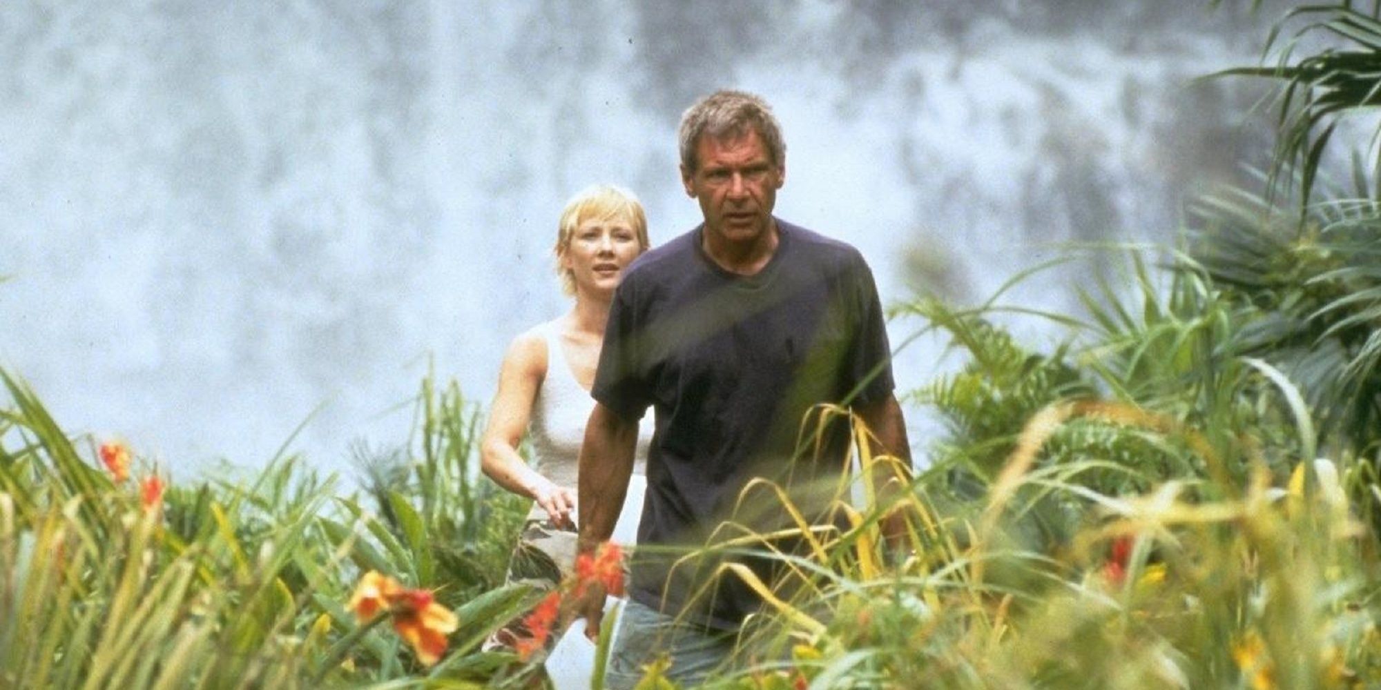 Harrison Ford and Anee Heche in a tropical island grass field in Six Days, Seven Nights.