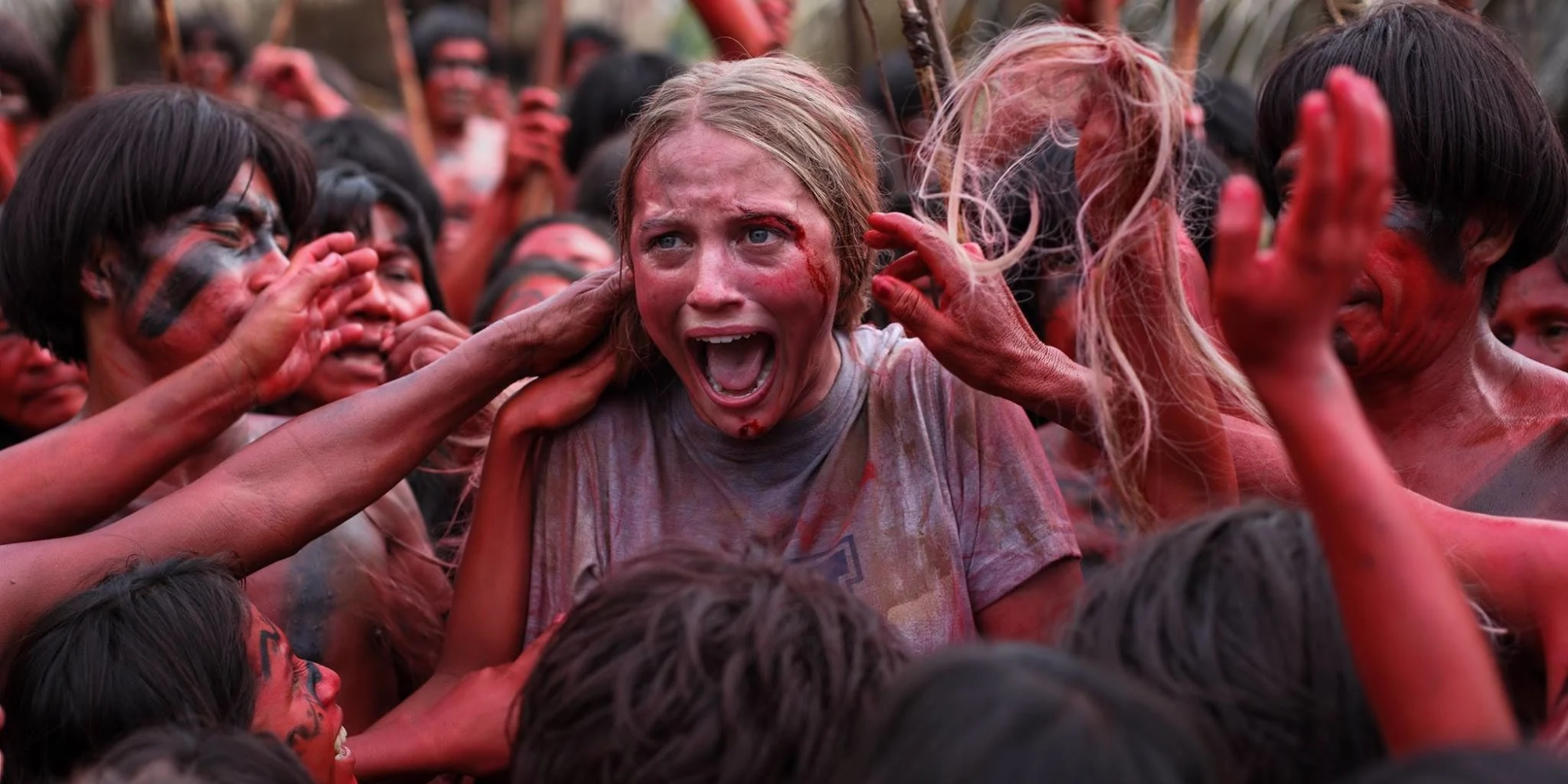 A woman screaming as she's touched by tribespeople