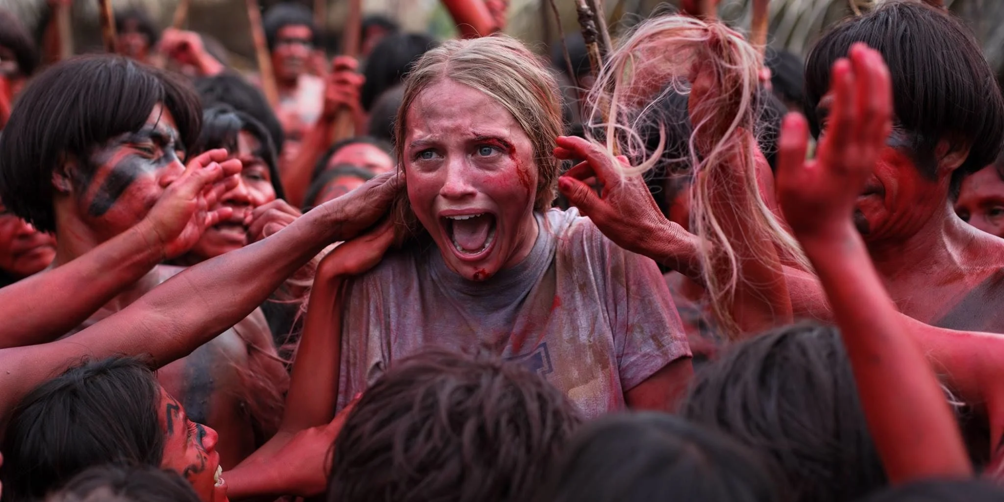 A woman screaming as she's touched by tribespeople in The Green Inferno.