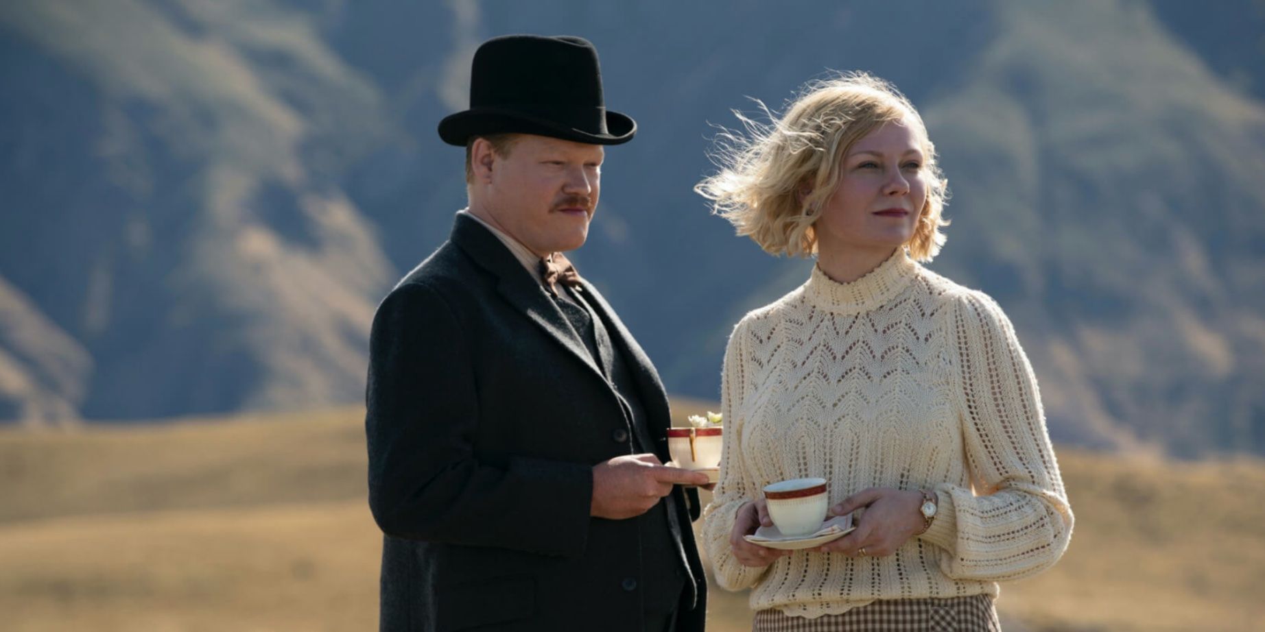 George and Rose holding teacups and staring into the distance in an open field in 