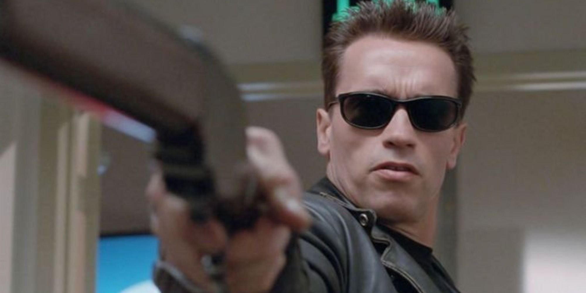 The Terminator wearing sunglasses and pointing gun