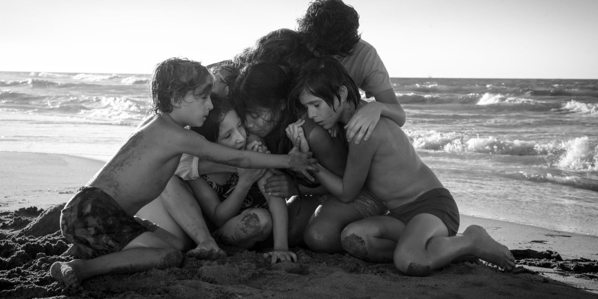 the family of "Roma", hugging in the beach