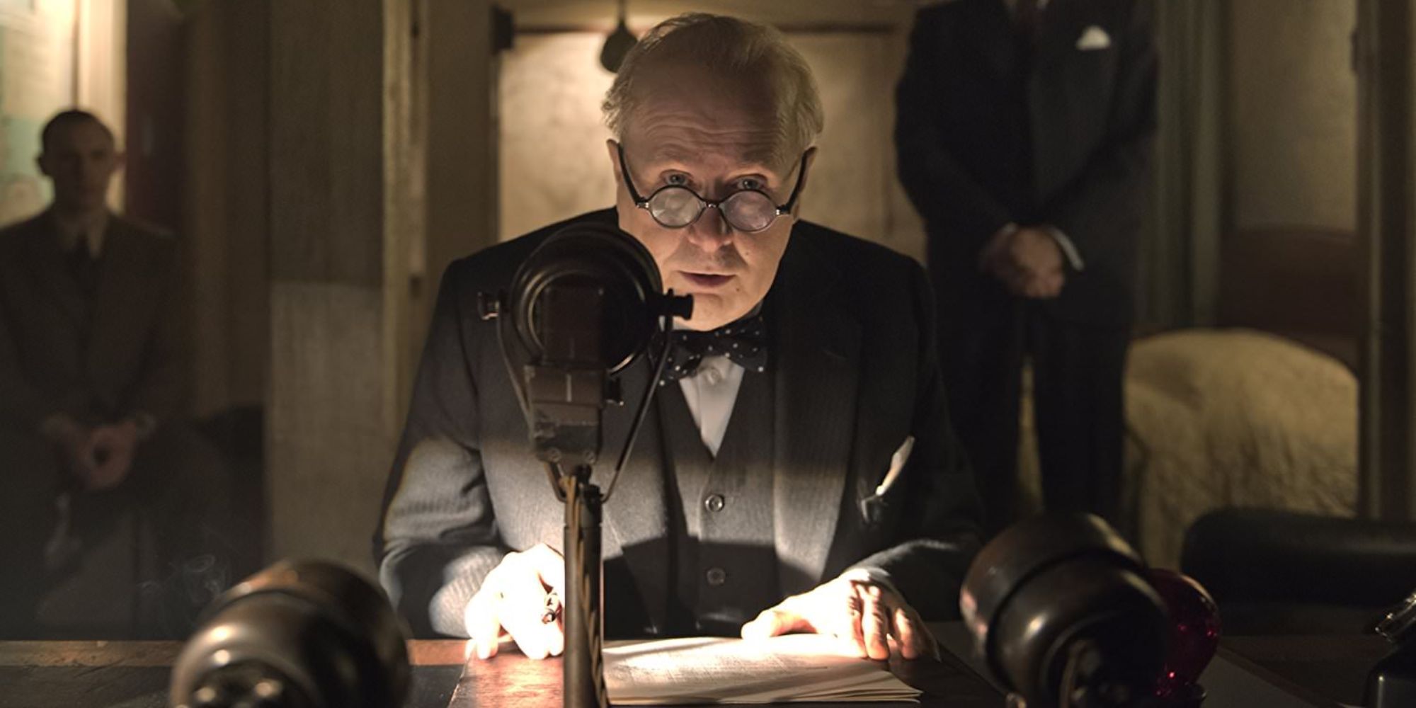 Gary Oldman as Winston Churchchill speaking to a mic in an underground bunker in Darkest Hour.