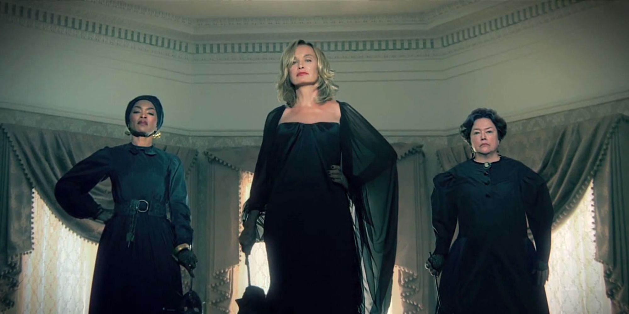 Jessica Lange, Angela Bassett, and Kathy Bates all posing in black clothing as witches from Coven