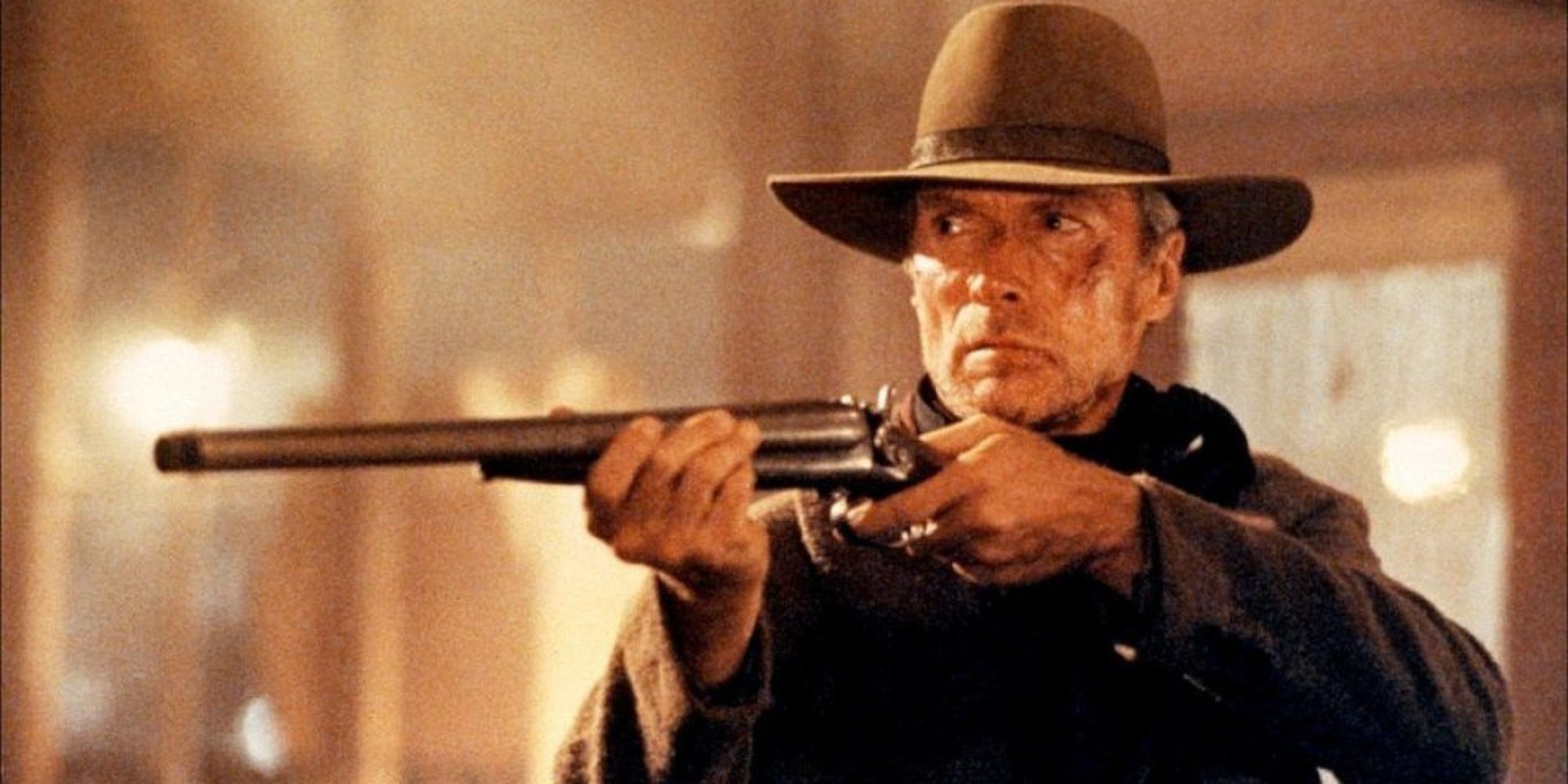 William Munny holding a shotgun in the saloon in Unforgiven