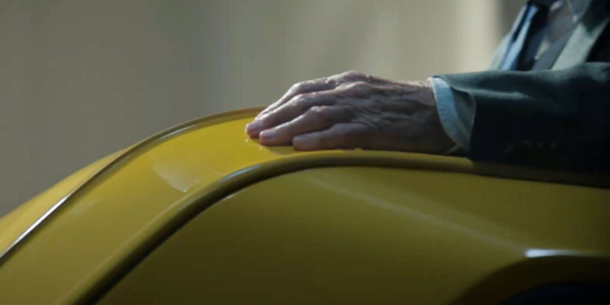 A hand on a yellow wheeling chair