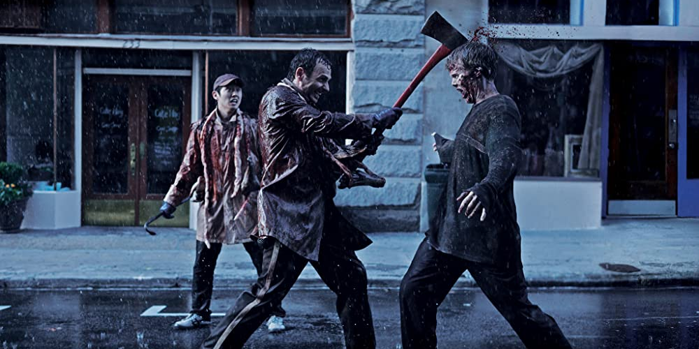 Rick killing a zombie with an axe while Glenn watches on in The Walking Dead