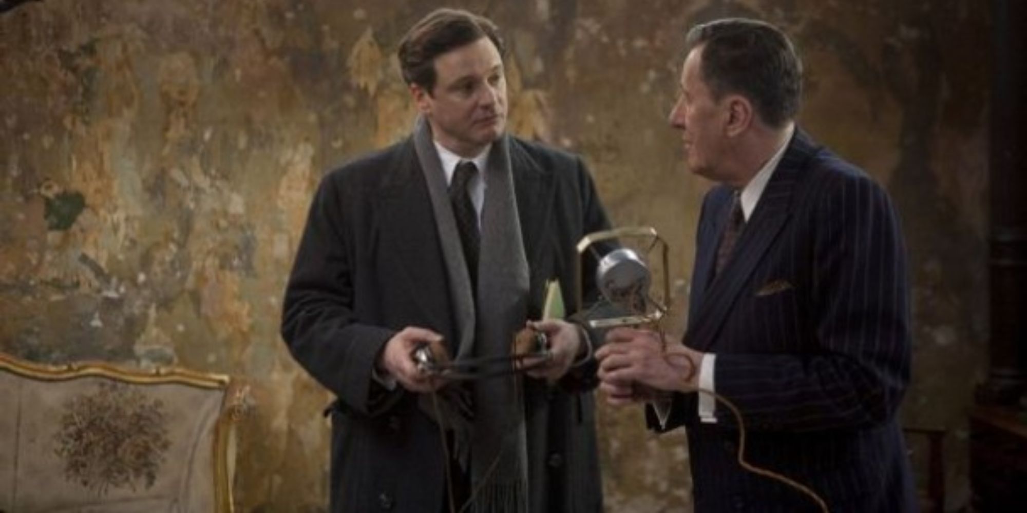 King George VI and Lionel Logue talking with a microphone in The King&rsquo;s Speech