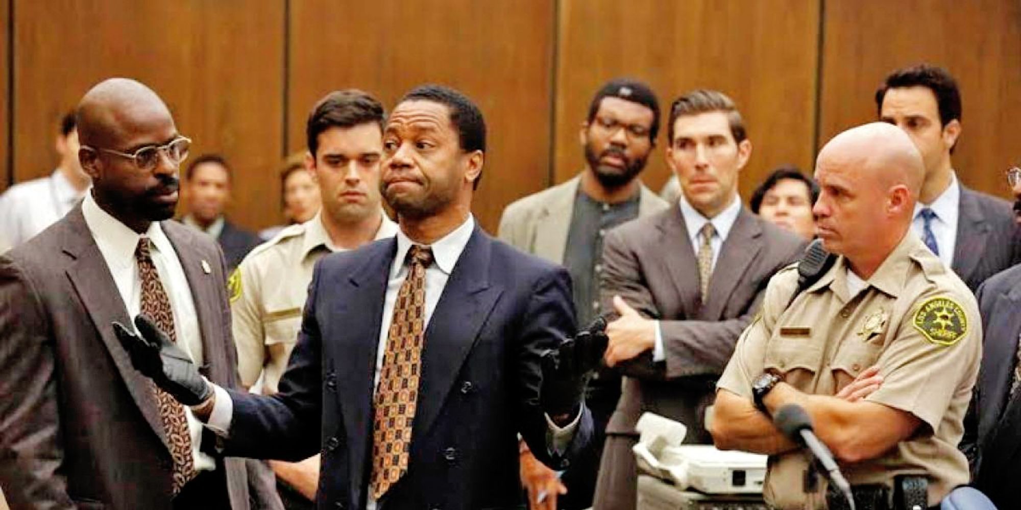 People are gathering around a black man in court
