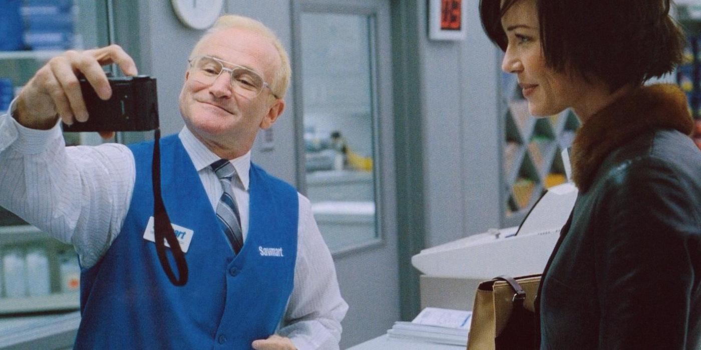 Robin Williams and Connie Nielsen as Sy Parrish and Nina Yorkin, as Sy takes a photo of himself smiling in One Hour Photo