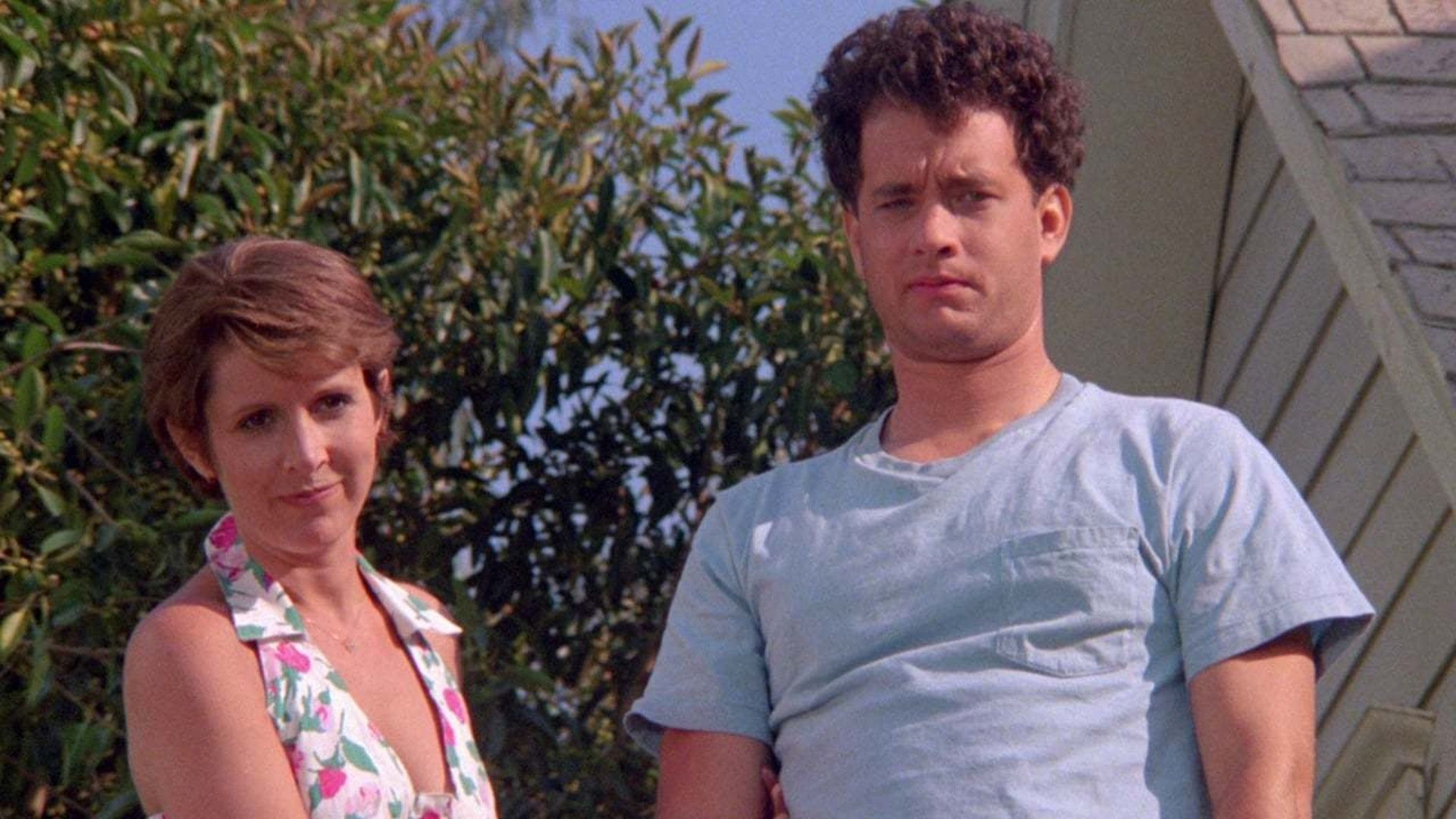 Tom Hanks as Ray Peterson stands with his wife Carrie Fisher as Carol in The Burbs