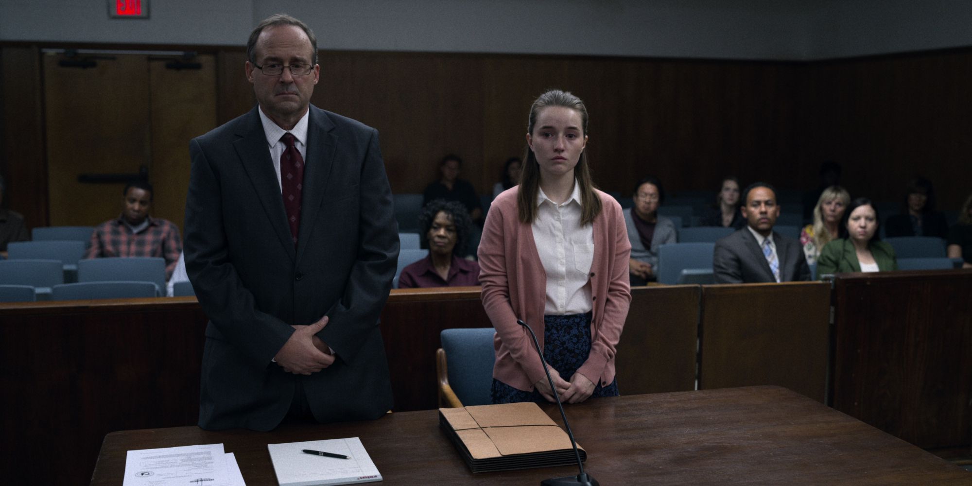 A girl and her attorney standing at the court