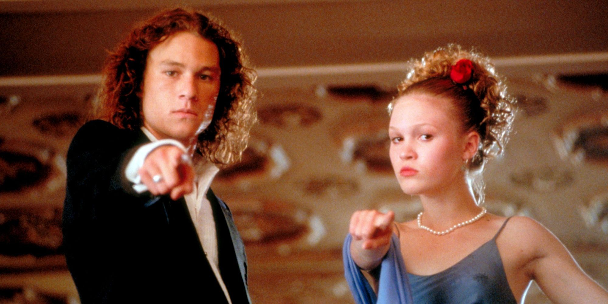 Patrick and Kat from 10 Things I Hate About You standing together and pointing at the camera.