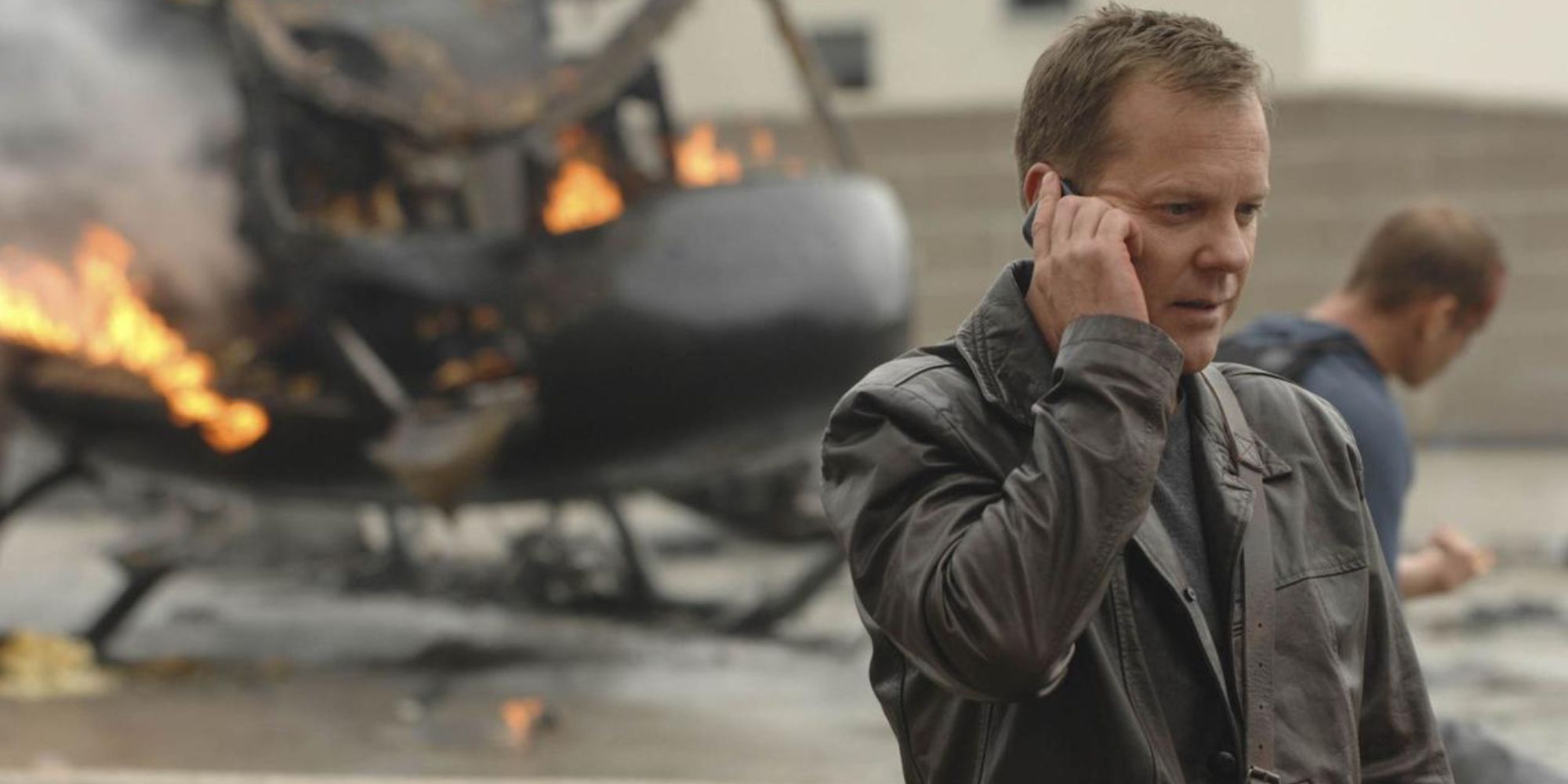 Jack Bauer on the phone in 24, a helicopter in flames behind him