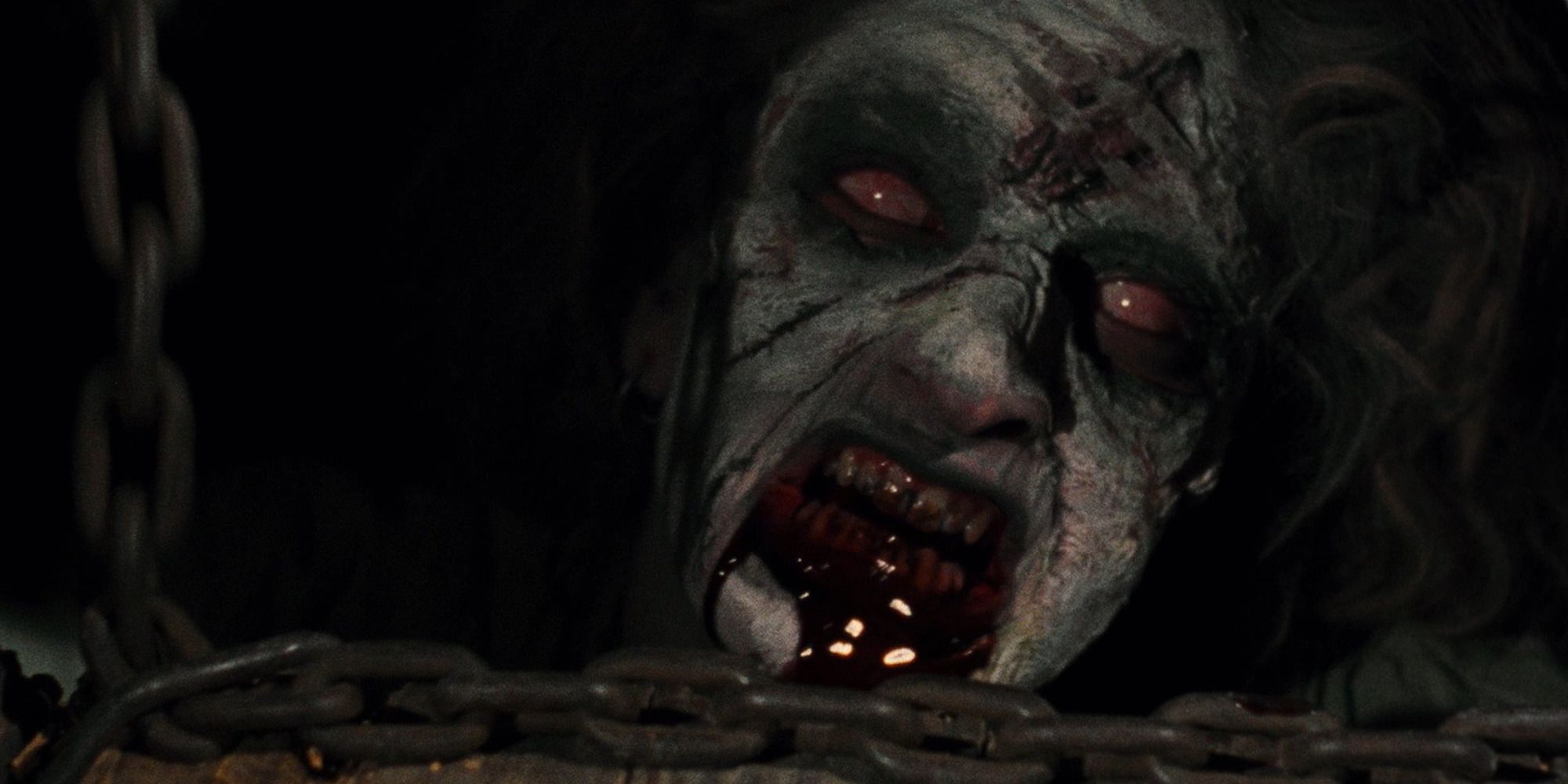 Dead man in The Evil Dead with blood in his mouth peeking from the floor