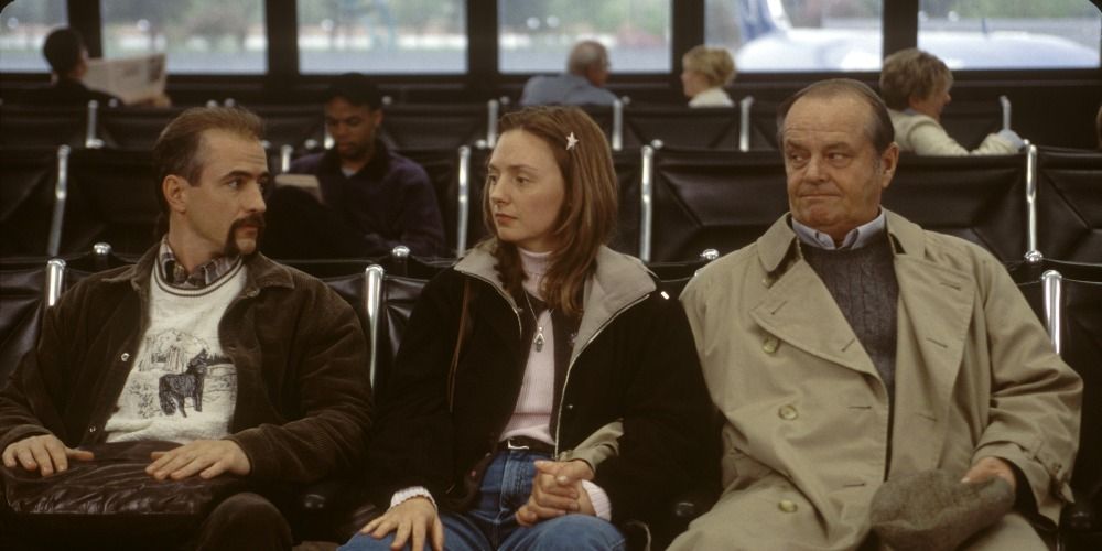 A young couple and an older man sitting side by side and looking uncomfortable in About Schmidt.