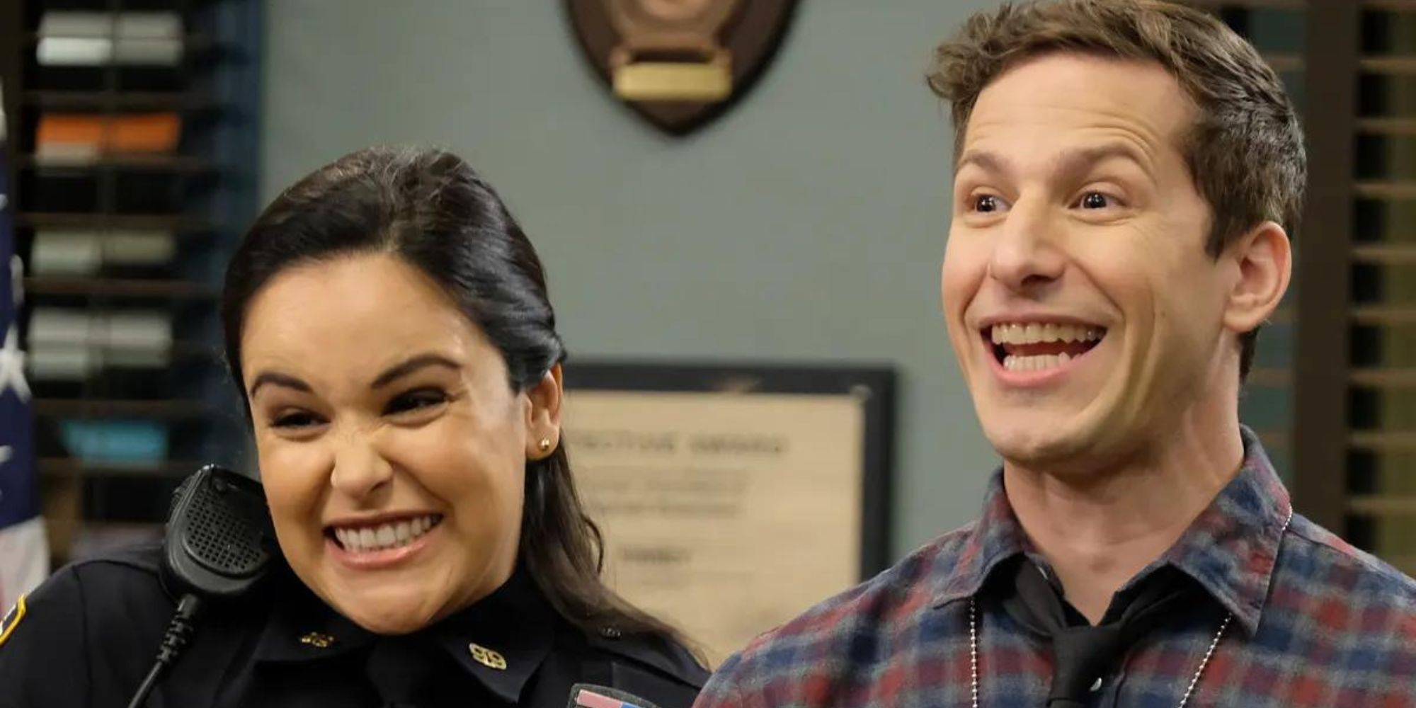 Jake and Amy from Brooklyn Nine-Nine smiling and squealing