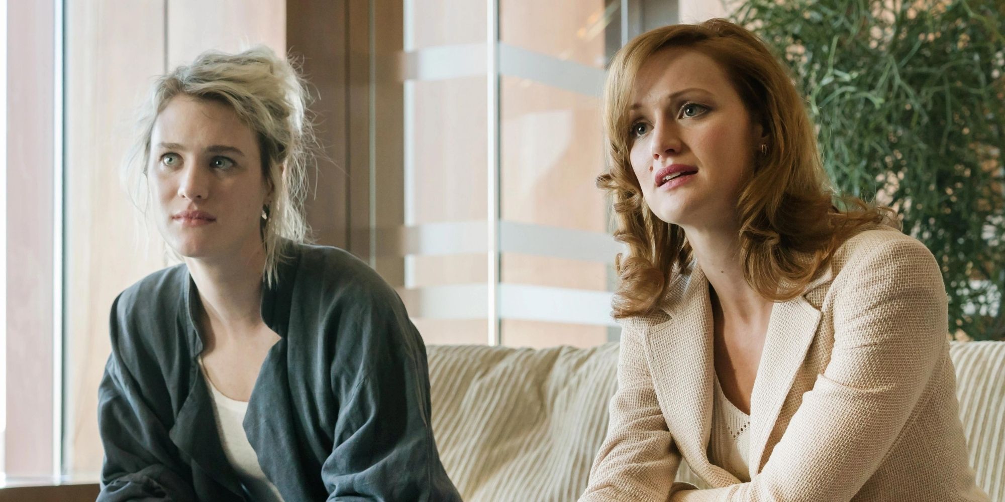 Two women sitting on a couch looking intense on Halt and Catch Fire.