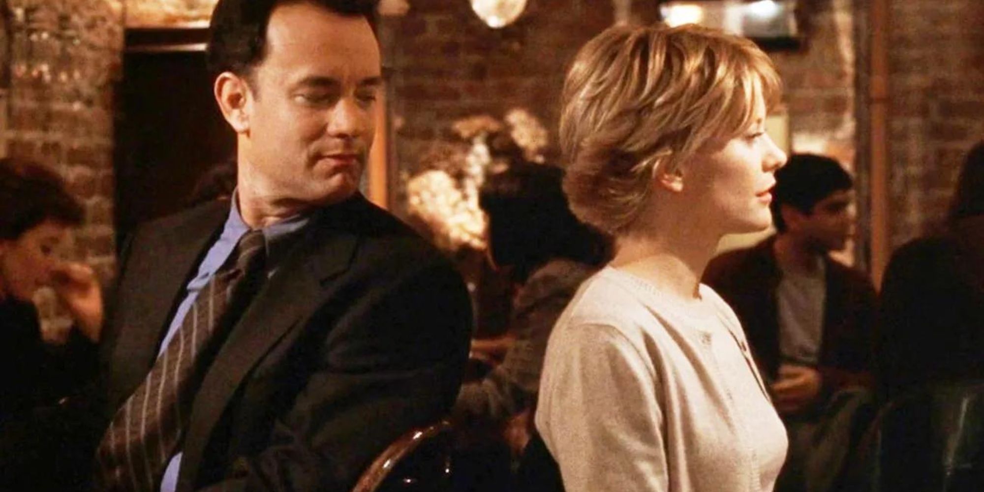 Kathleen and Joe from You've Got Mail sitting on chairs with their backs turned while Joe stares at her