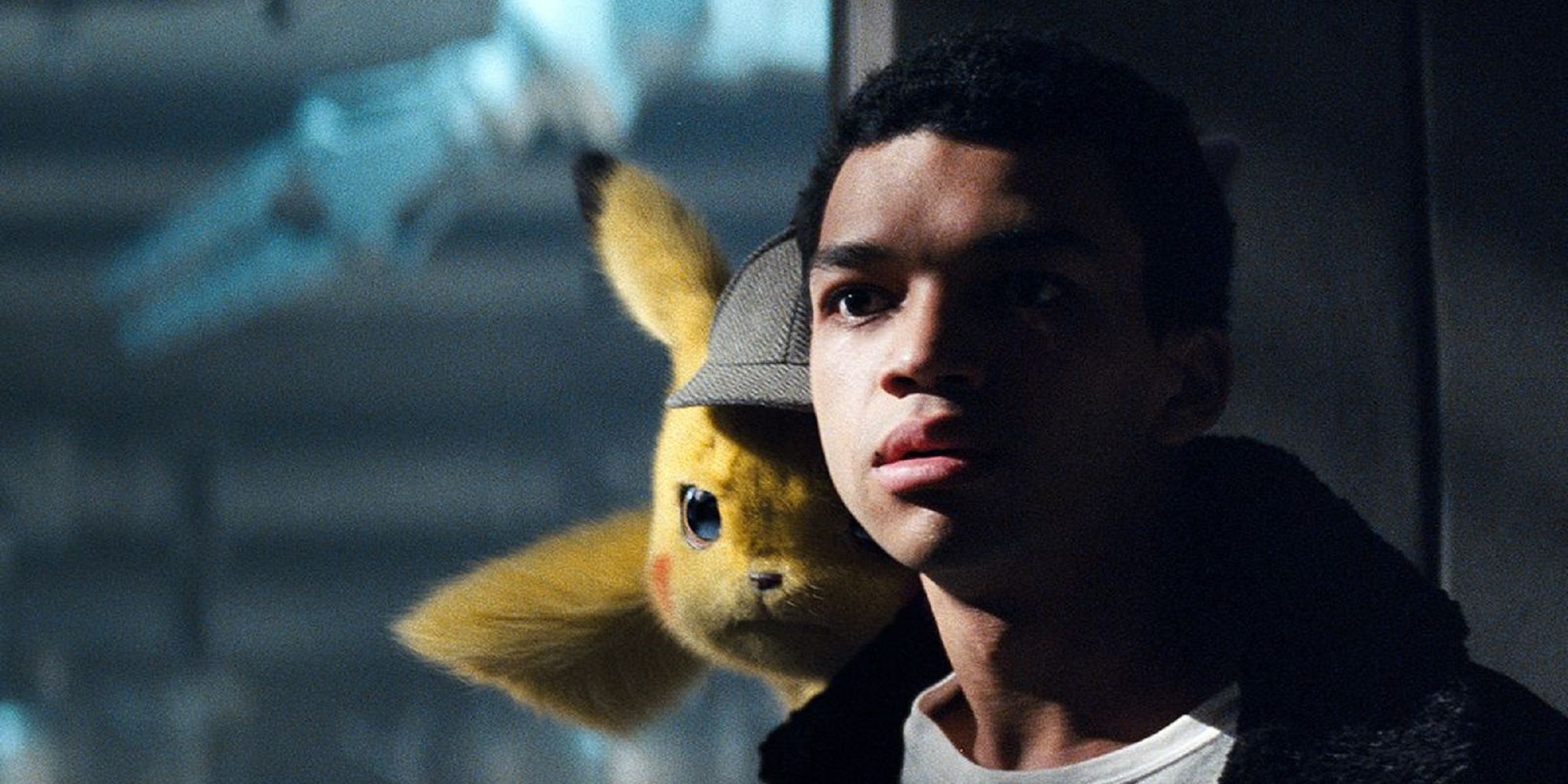 Tim and Pikachu looking out a window in Detective Pikachu.