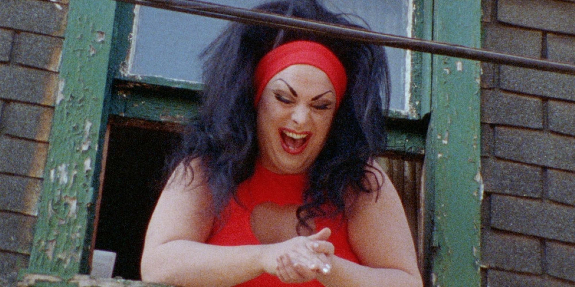 Divine hanging out of her window in Female Trouble.