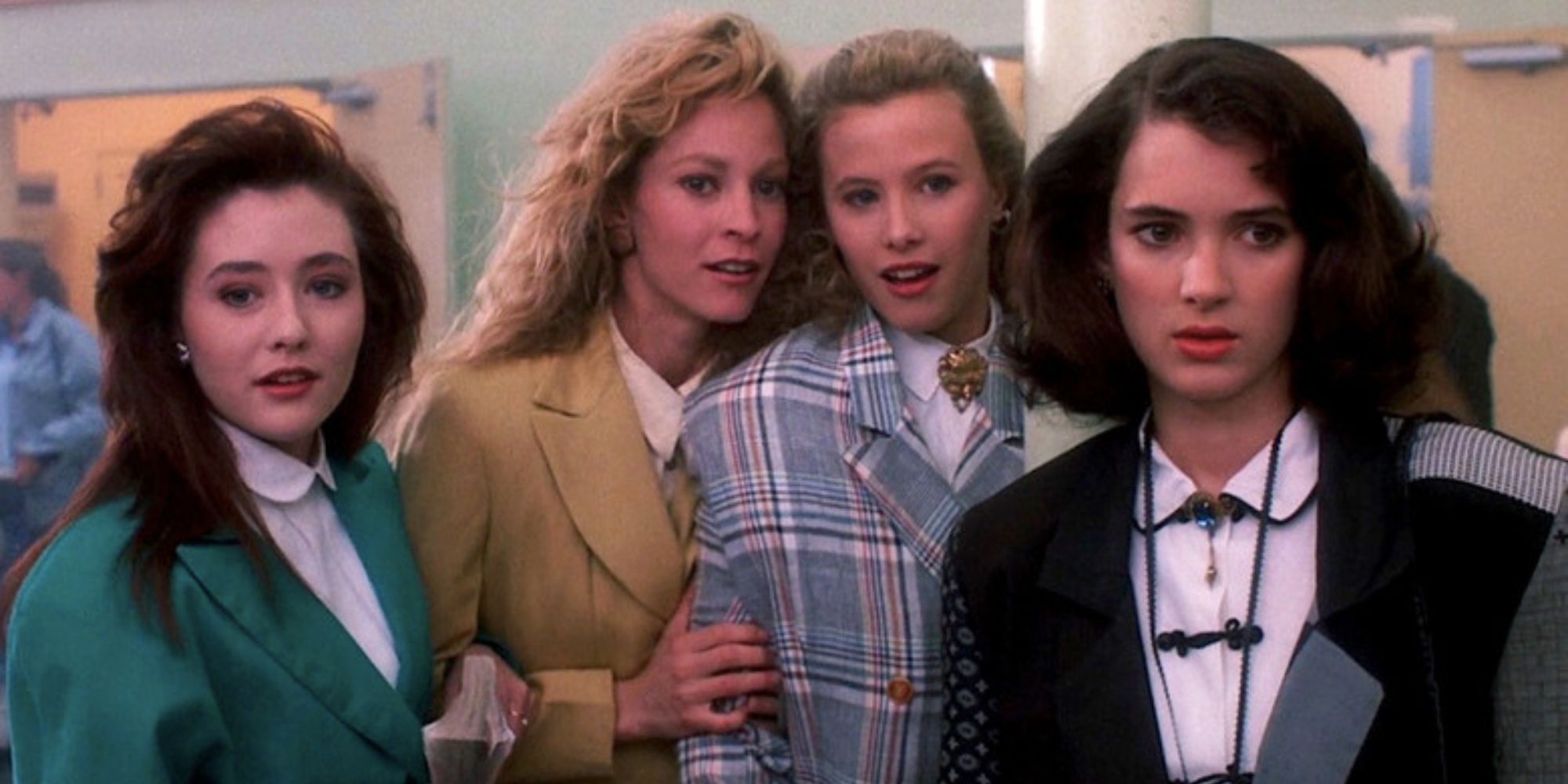 Winona Ryder as Veronica and Shannon Doherty, Lisanne Falk, and Kim Walker as three Heathers standing together in Heathers