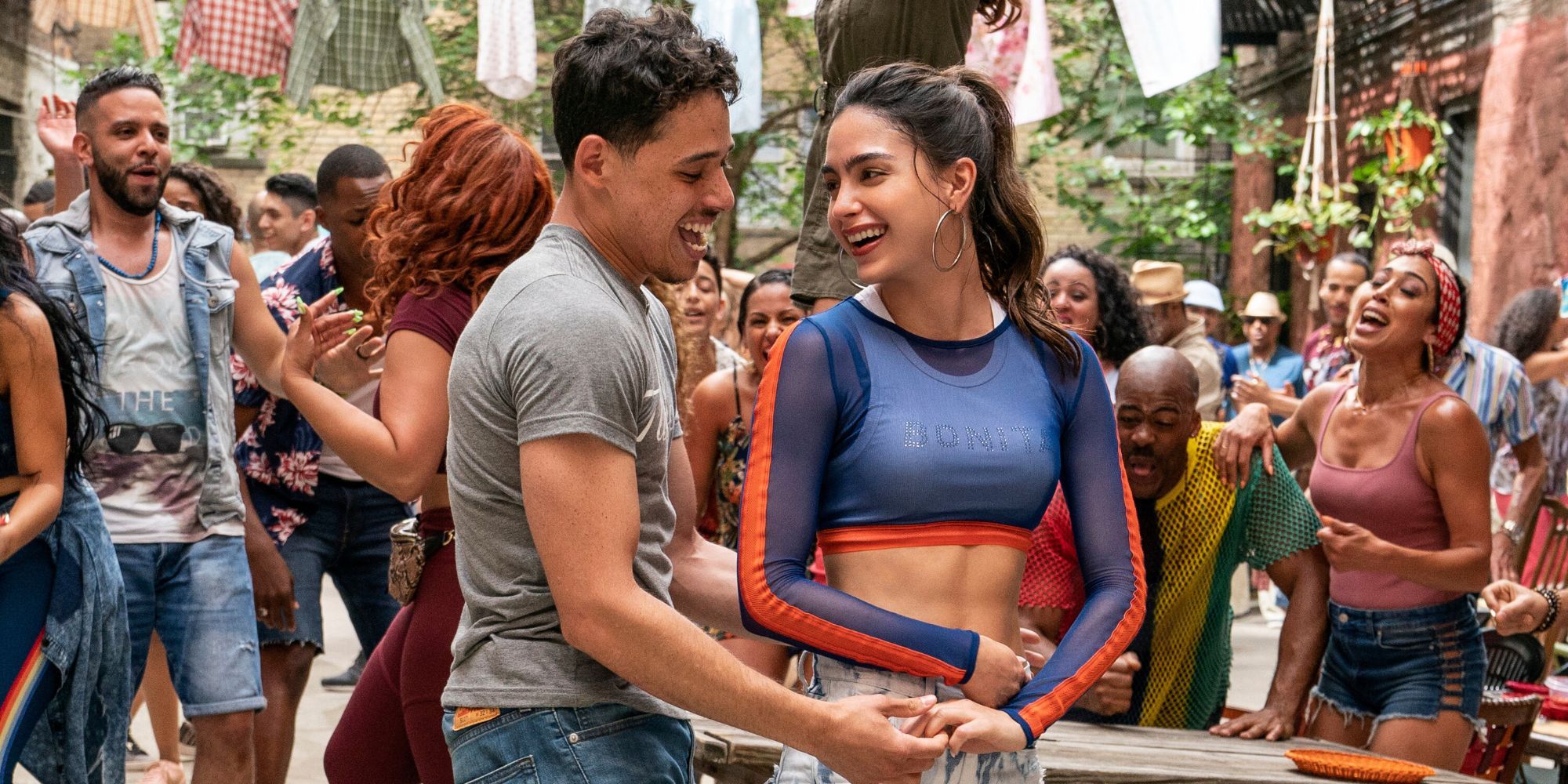 Usnavi and Vanessa dancing together with others in the background in In The Heights.