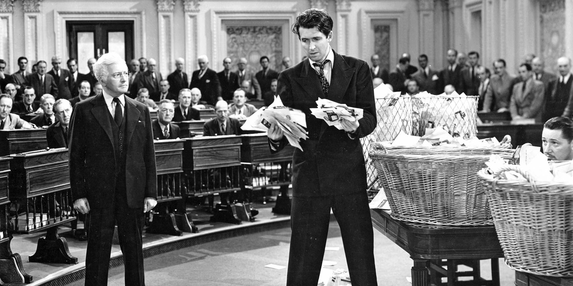 James Stewart and Claude Rains in a courtroom with two baskets of papers in Mr Smith Goes to Washington